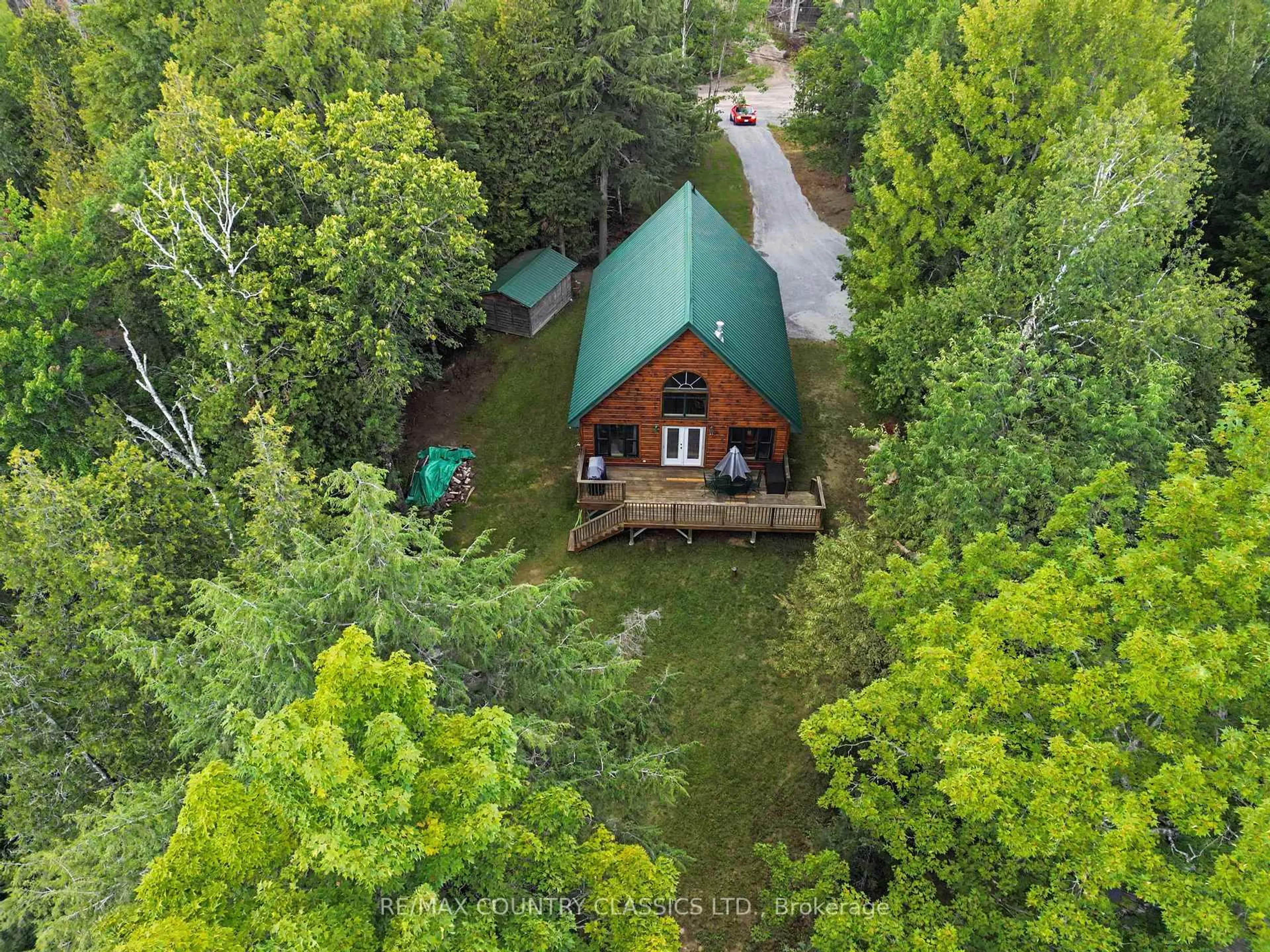 A pic from outside/outdoor area/front of a property/back of a property/a pic from drone, forest/trees view for 203 Doc Evans Rd, North Kawartha Ontario K0L 1A0