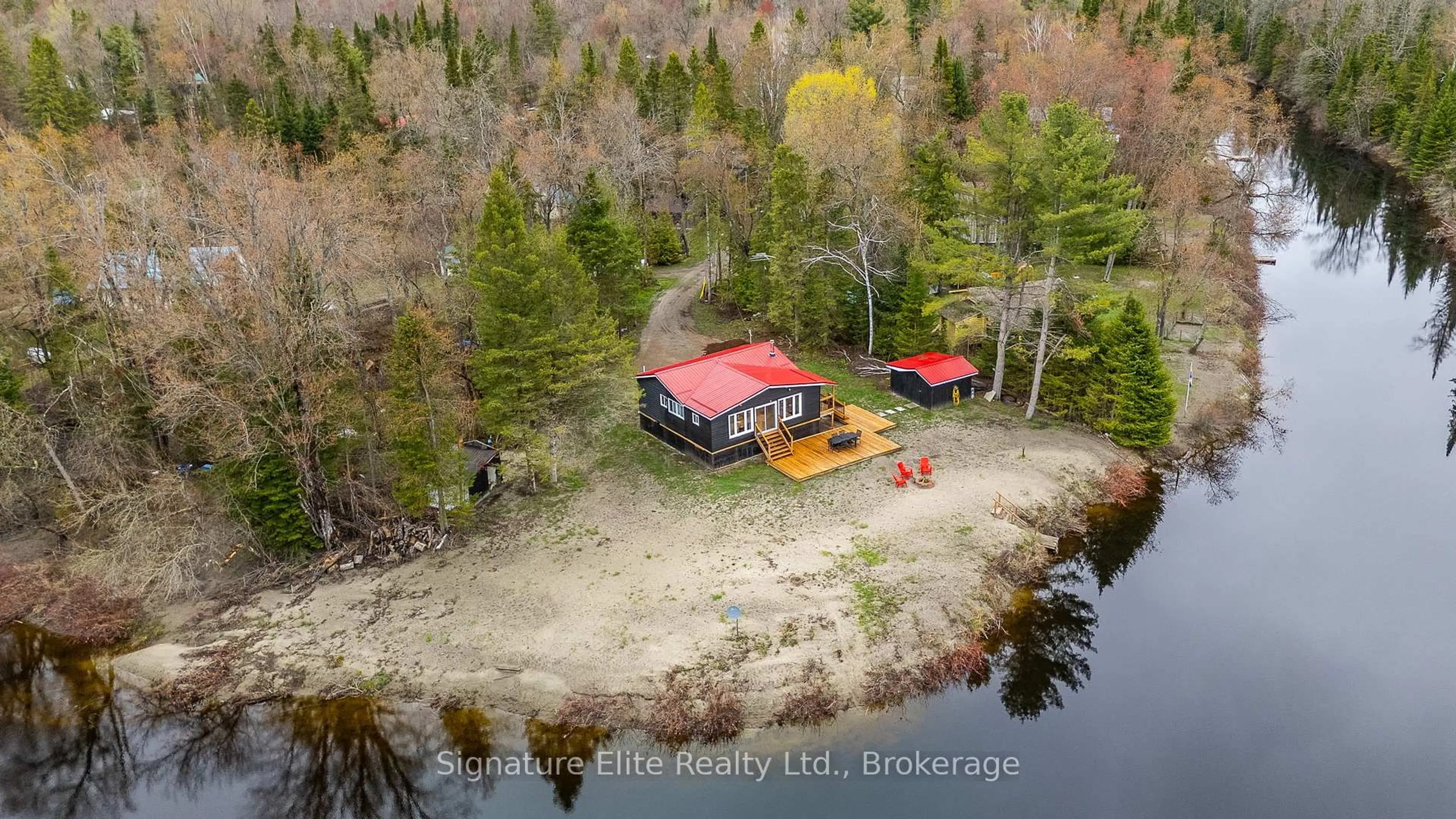 A pic from outside/outdoor area/front of a property/back of a property/a pic from drone, water/lake/river/ocean view for 1077 Nystedt Lane, Minden Hills Ontario K0M 2A1