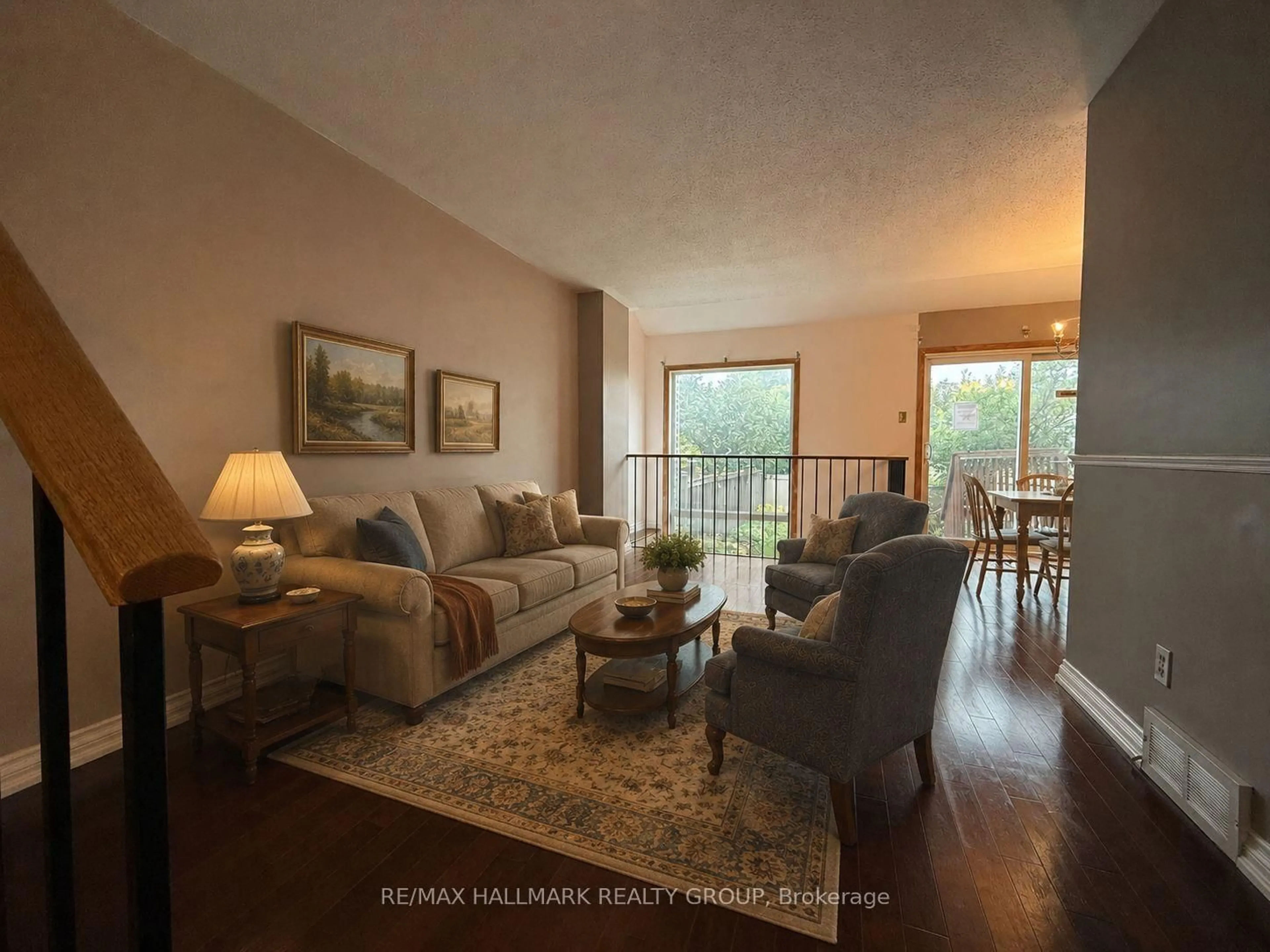 Living room with furniture, wood/laminate floor for 181 Tartan Dr, Barrhaven Ontario K2J 3S2