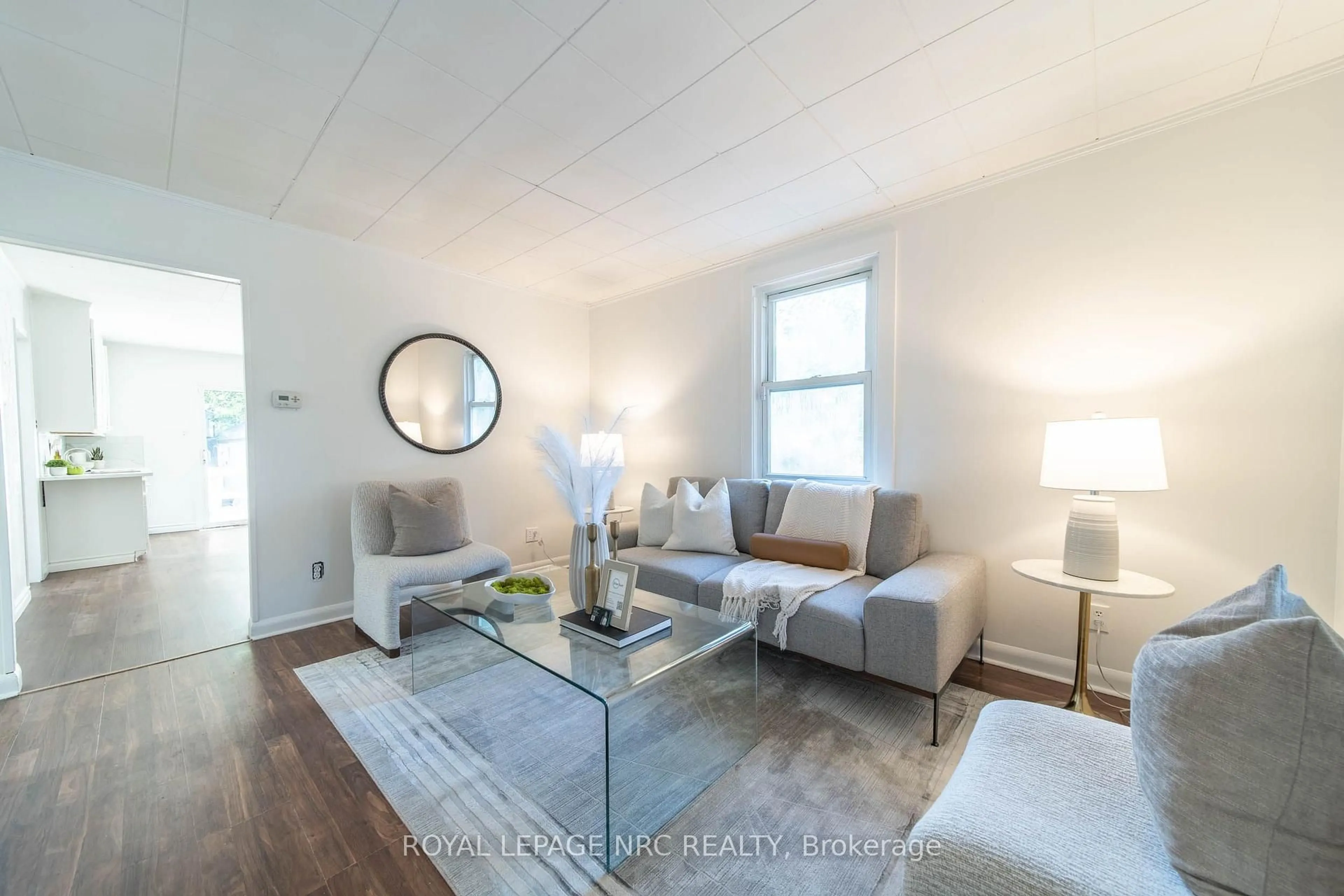 Living room with furniture, wood/laminate floor for 6255 Culp St, Niagara Falls Ontario L2G 2C2