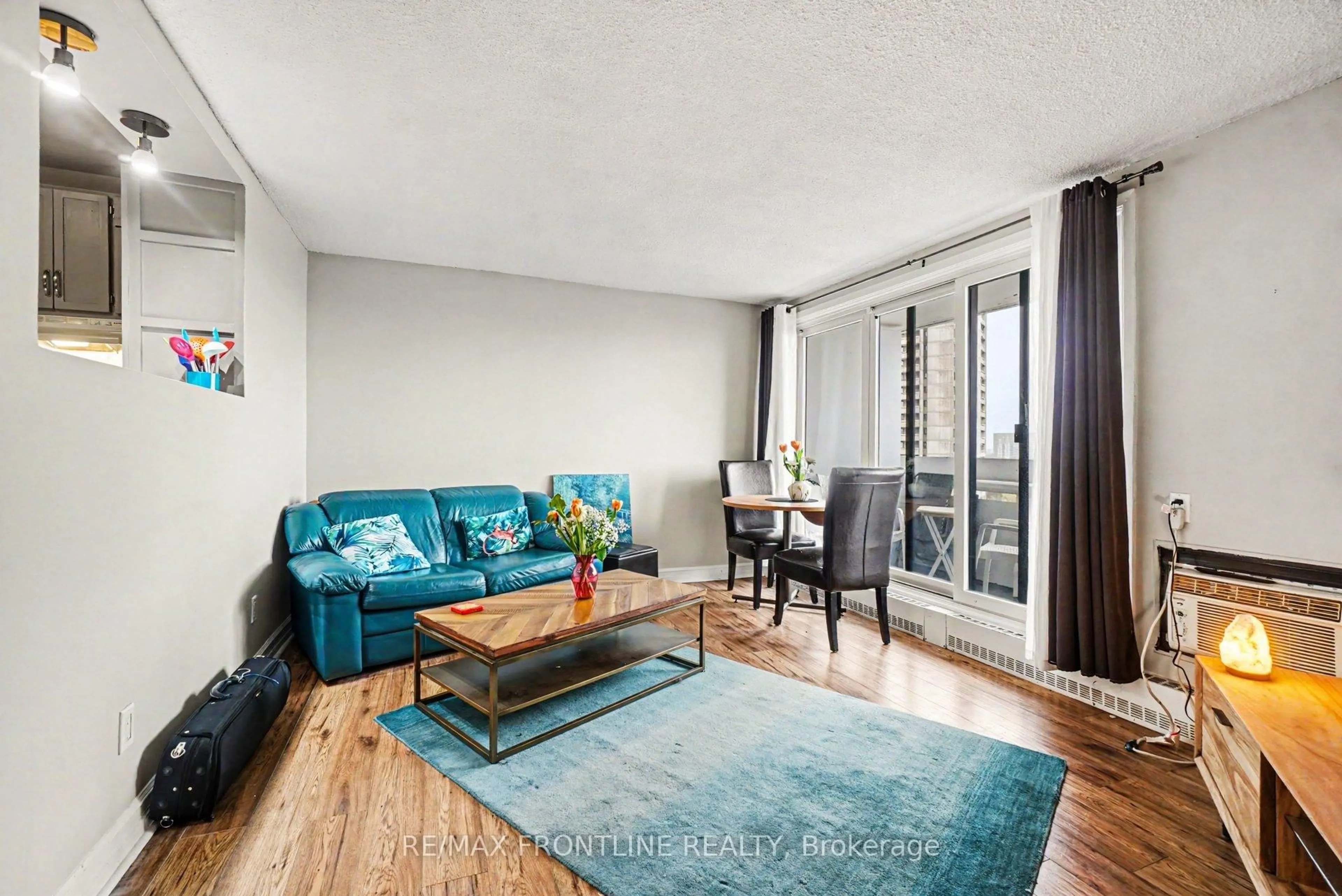Living room with furniture, wood/laminate floor for 1081 Ambleside Dr #1009, Ottawa Ontario K2B 8C8