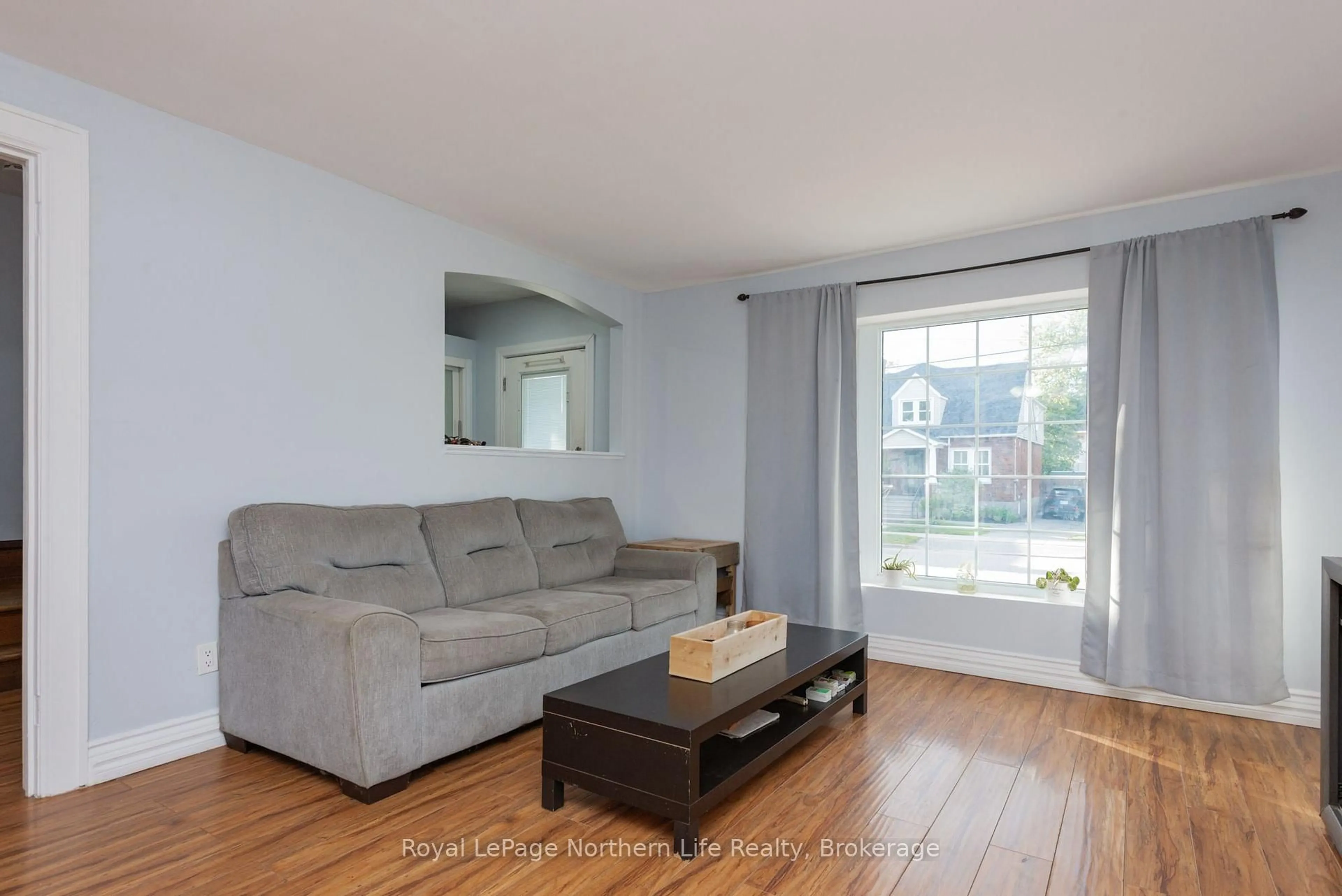 Living room with furniture, wood/laminate floor for 583 Wyld St, North Bay Ontario P1B 1Z8