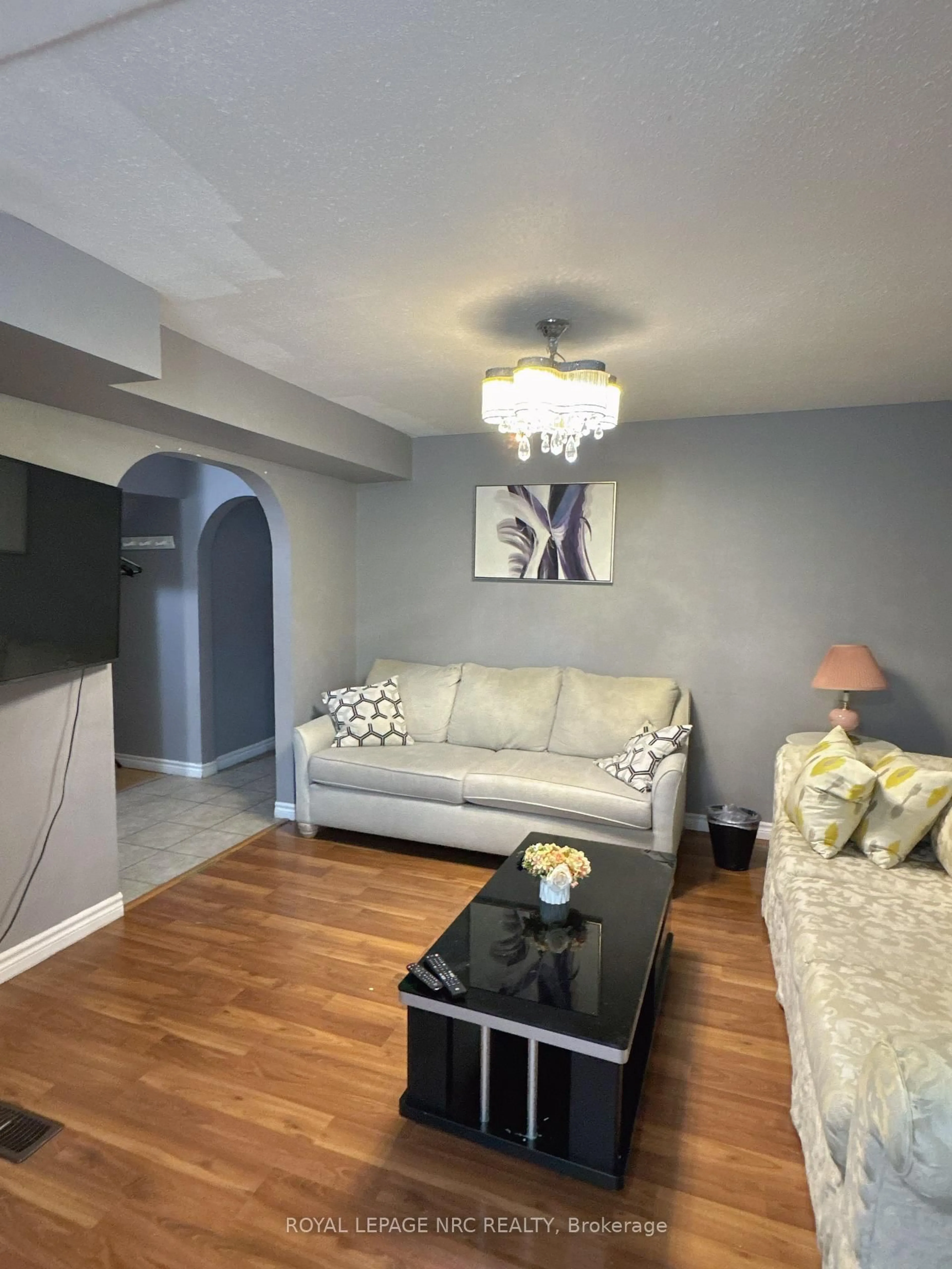 Living room with furniture, wood/laminate floor for 4148 Victoria Ave, Niagara Falls Ontario L2E 4B4