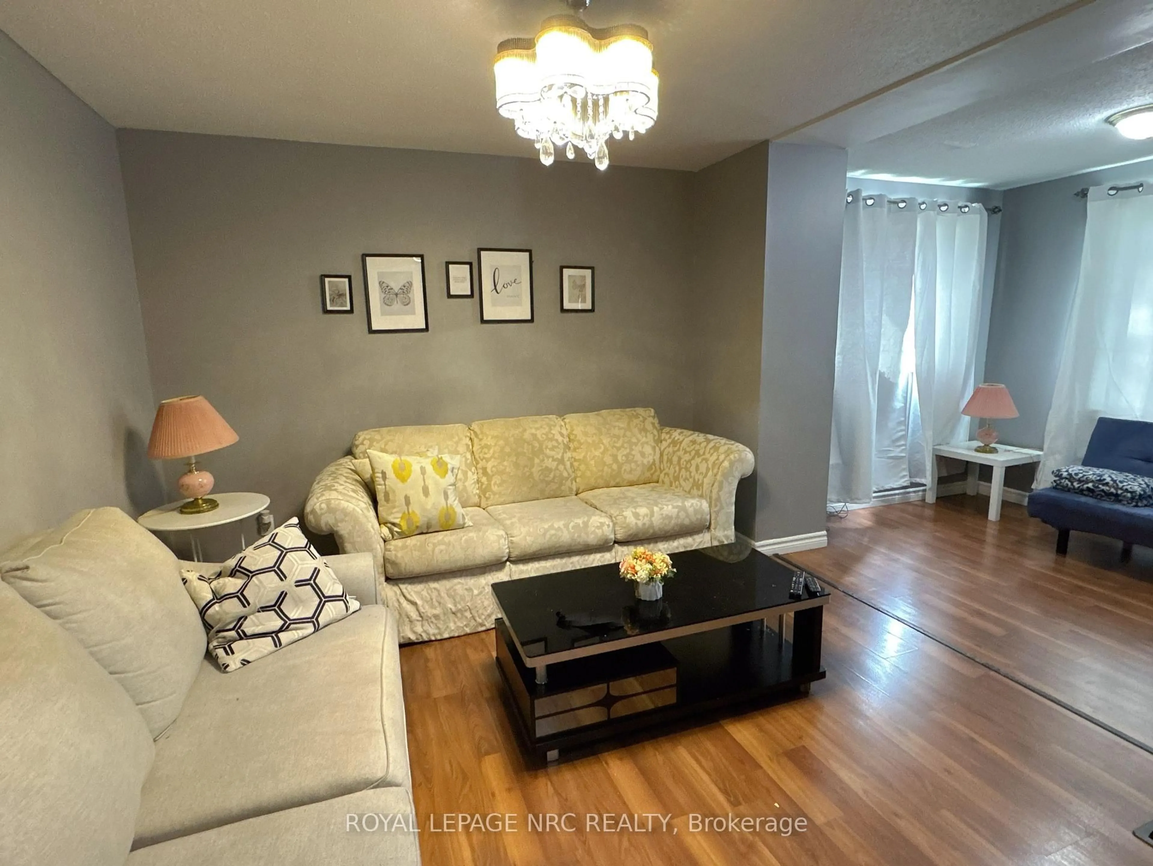 Living room with furniture, wood/laminate floor for 4148 Victoria Ave, Niagara Falls Ontario L2E 4B4