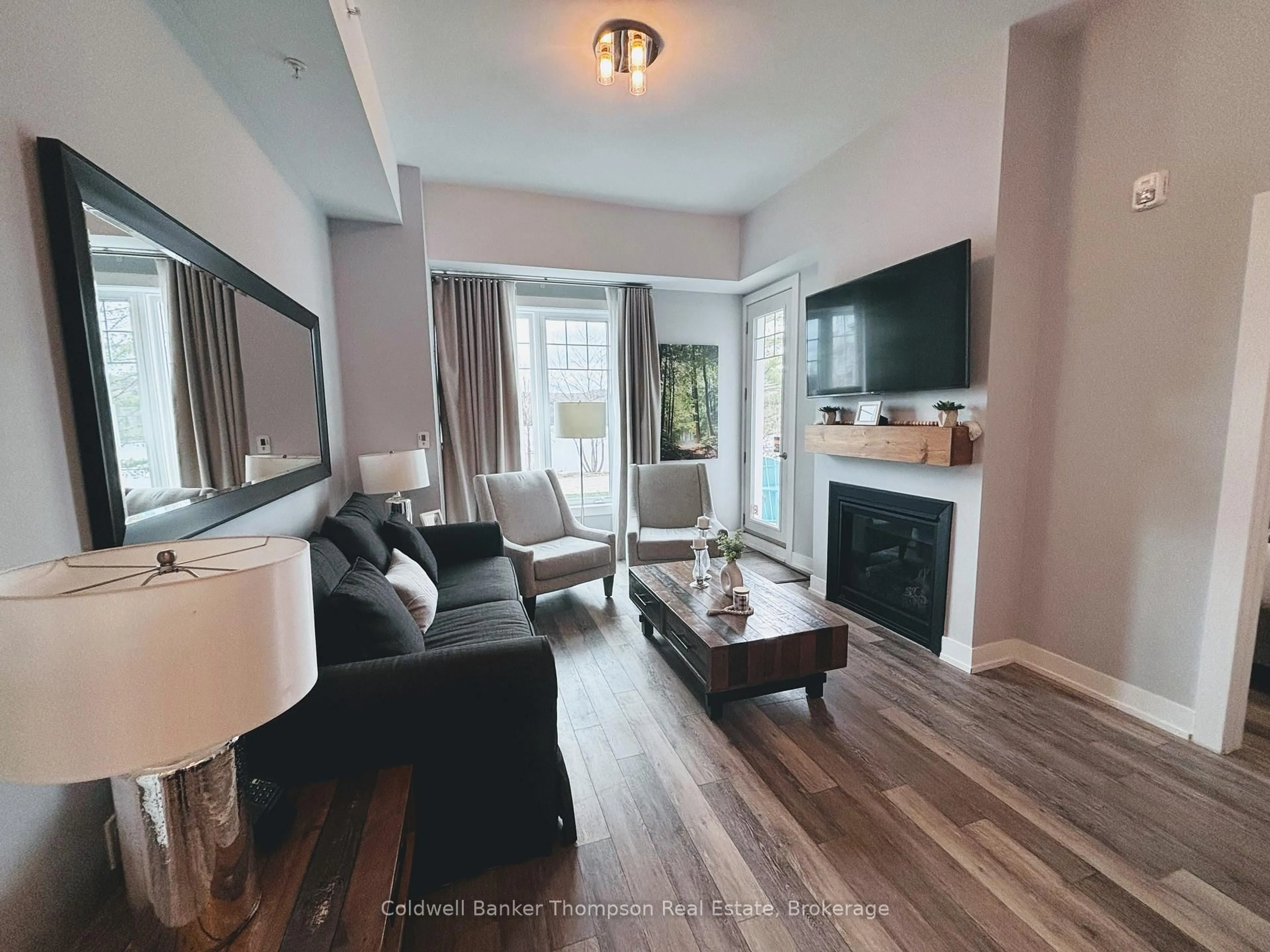 Living room with furniture, wood/laminate floor for 25 Pen Lake Point Rd #003, Huntsville Ontario P1H 1A9