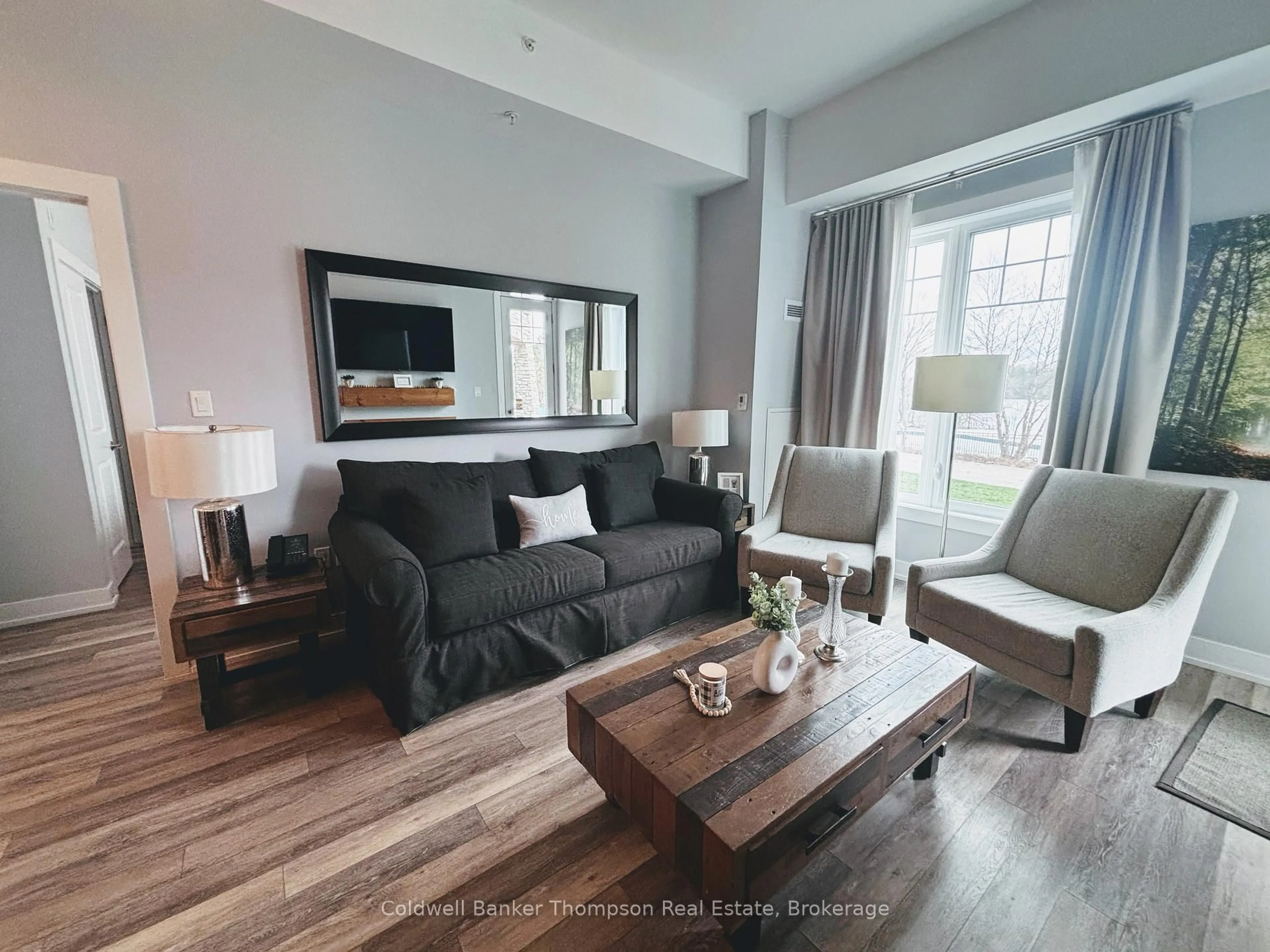 Living room with furniture, wood/laminate floor for 25 Pen Lake Point Rd #003, Huntsville Ontario P1H 1A9
