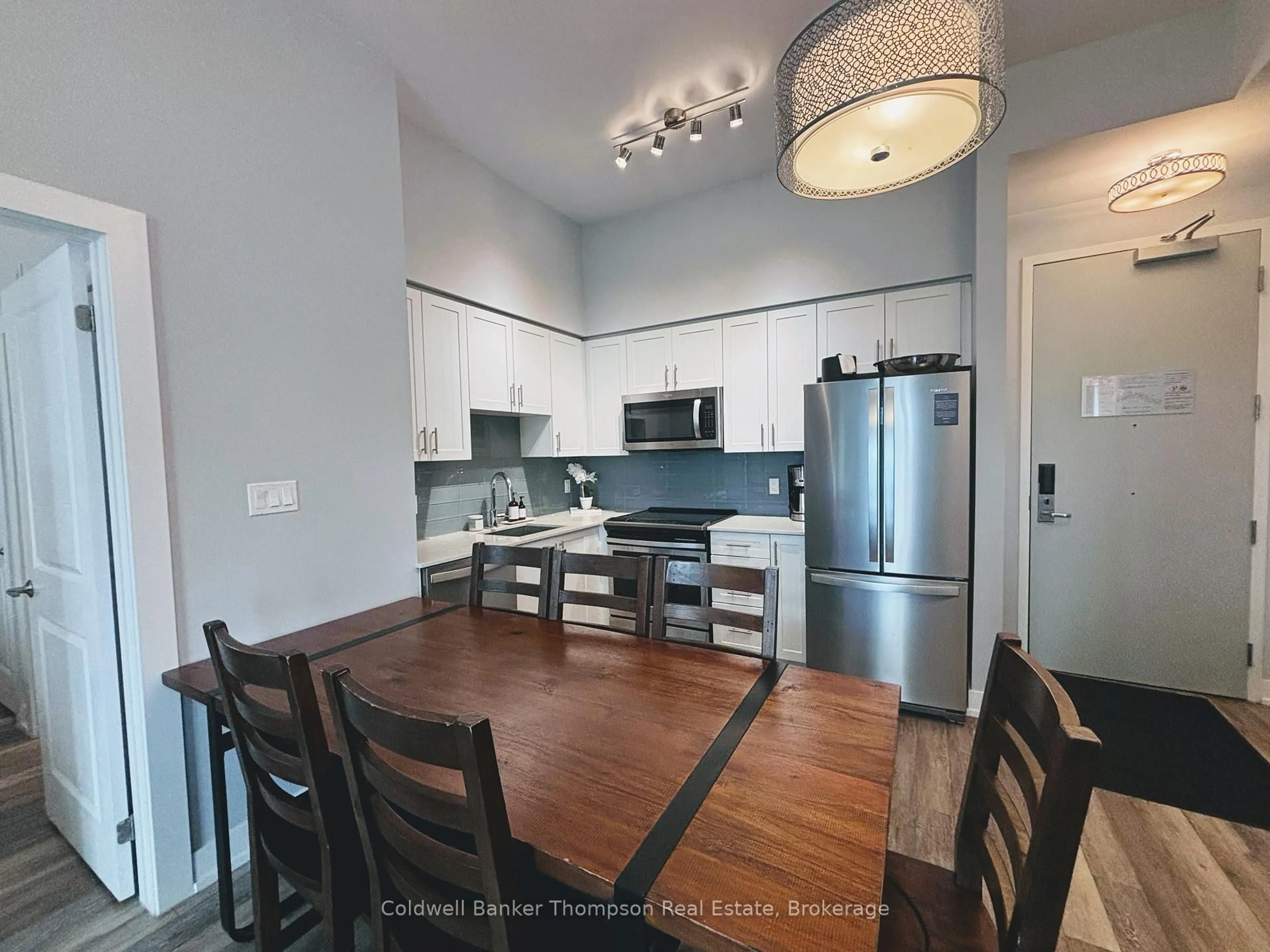 Open concept kitchen, wood/laminate floor for 25 Pen Lake Point Rd #003, Huntsville Ontario P1H 1A9