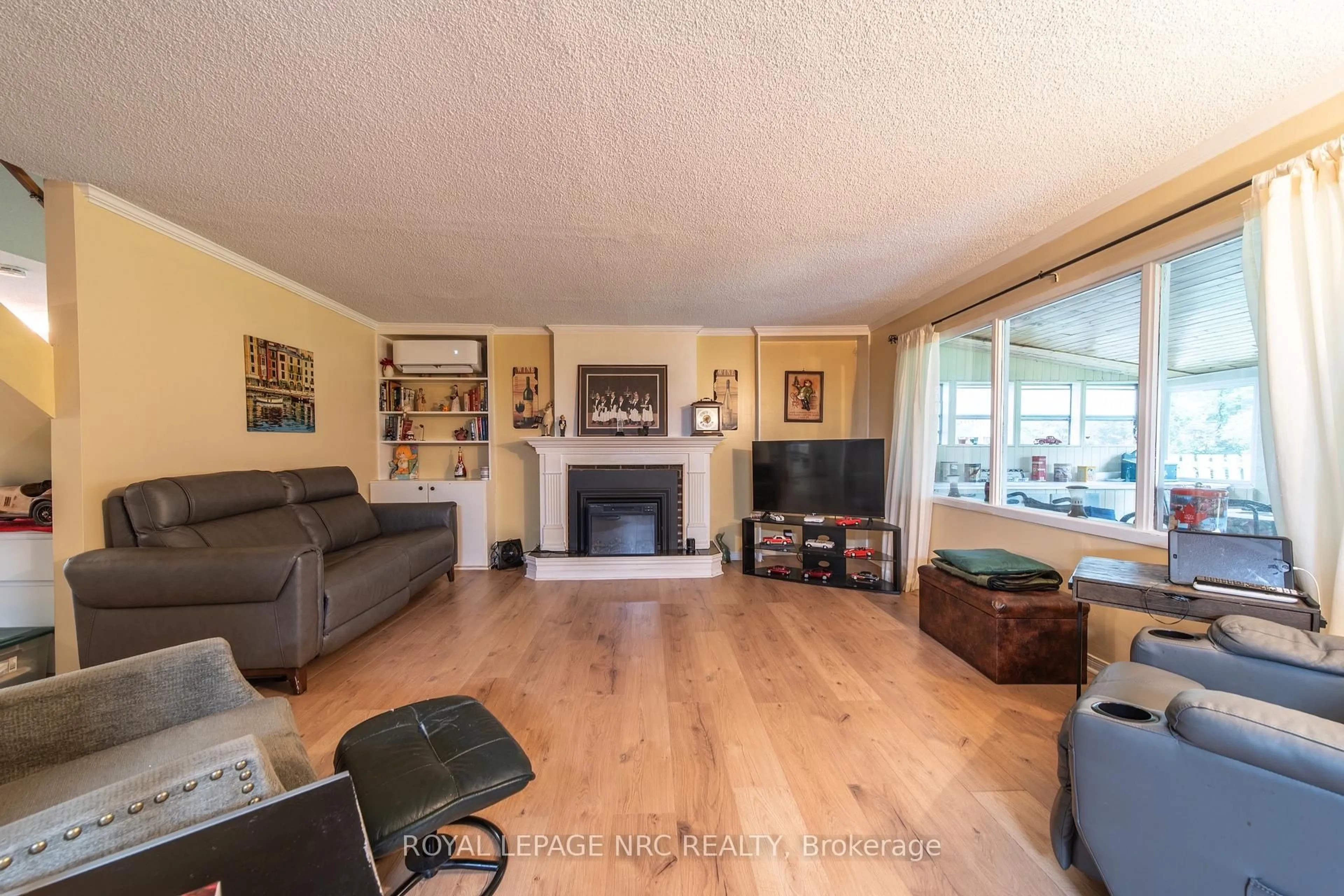 Living room with furniture, wood/laminate floor for 6334 Frederica St, Niagara Falls Ontario L2G 1C4