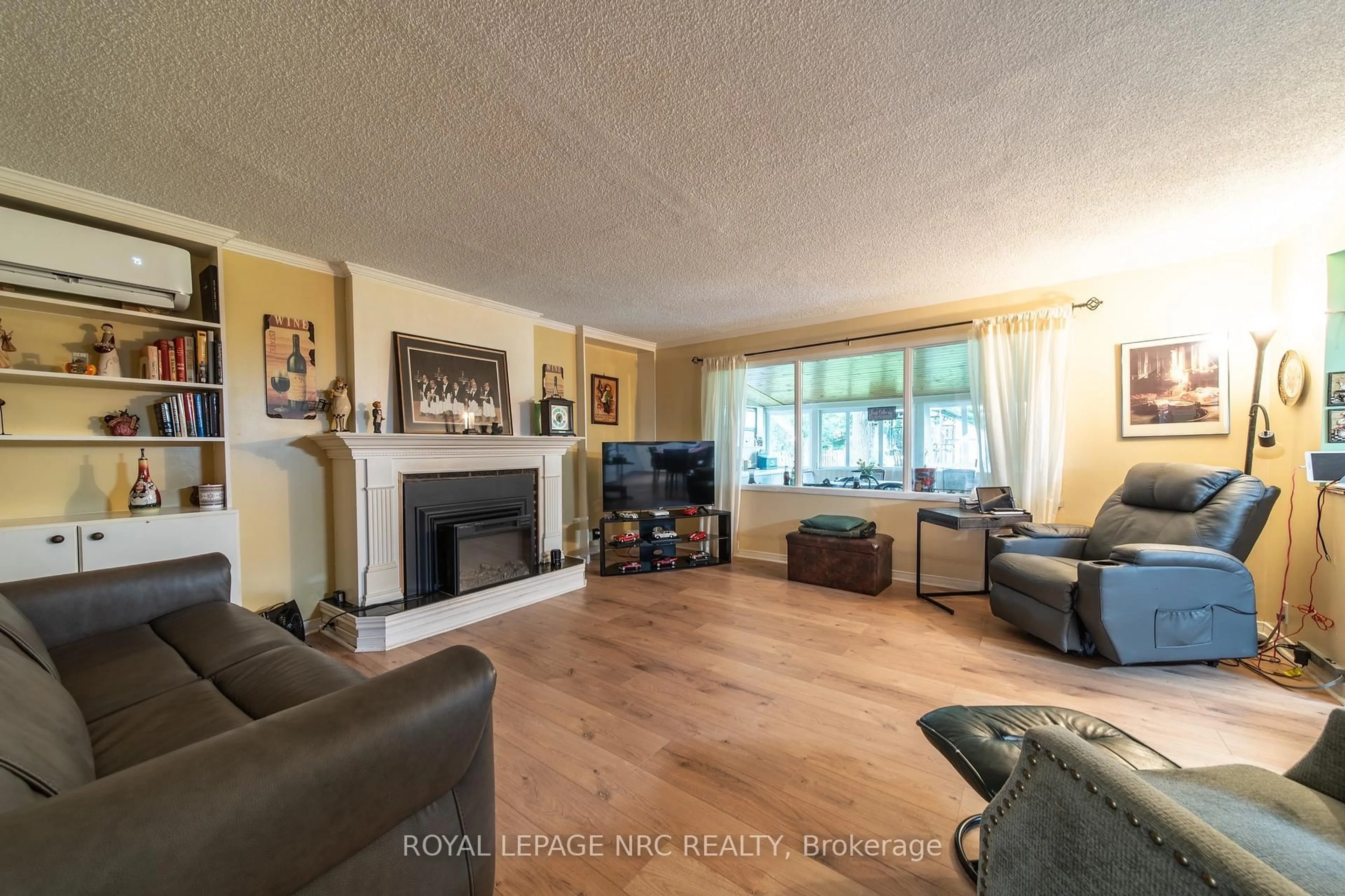 Living room with furniture, wood/laminate floor for 6334 Frederica St, Niagara Falls Ontario L2G 1C4