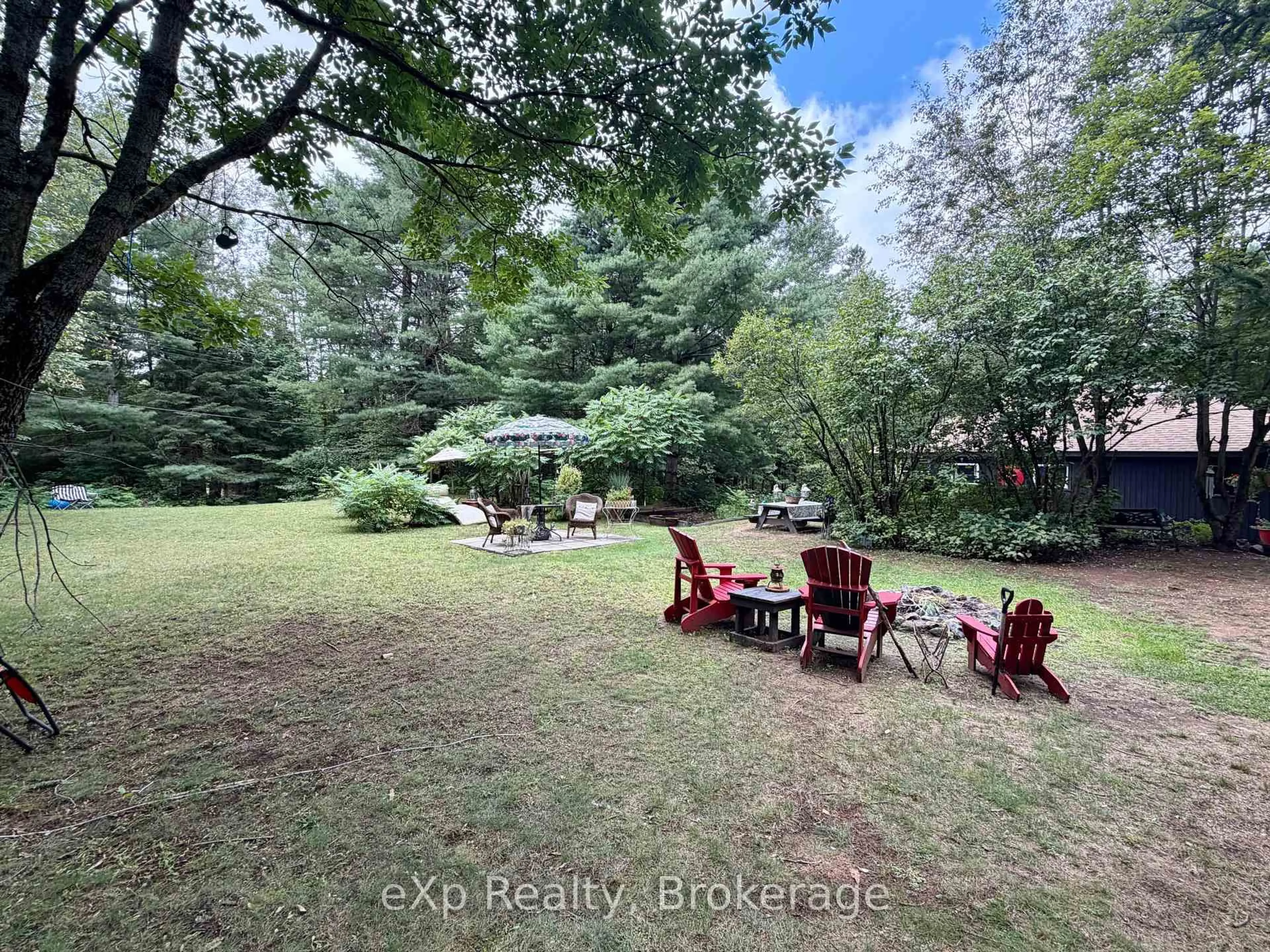 A pic from outside/outdoor area/front of a property/back of a property/a pic from drone, forest/trees view for 1116 Springdale Park Rd, Bracebridge Ontario P1L 1W9