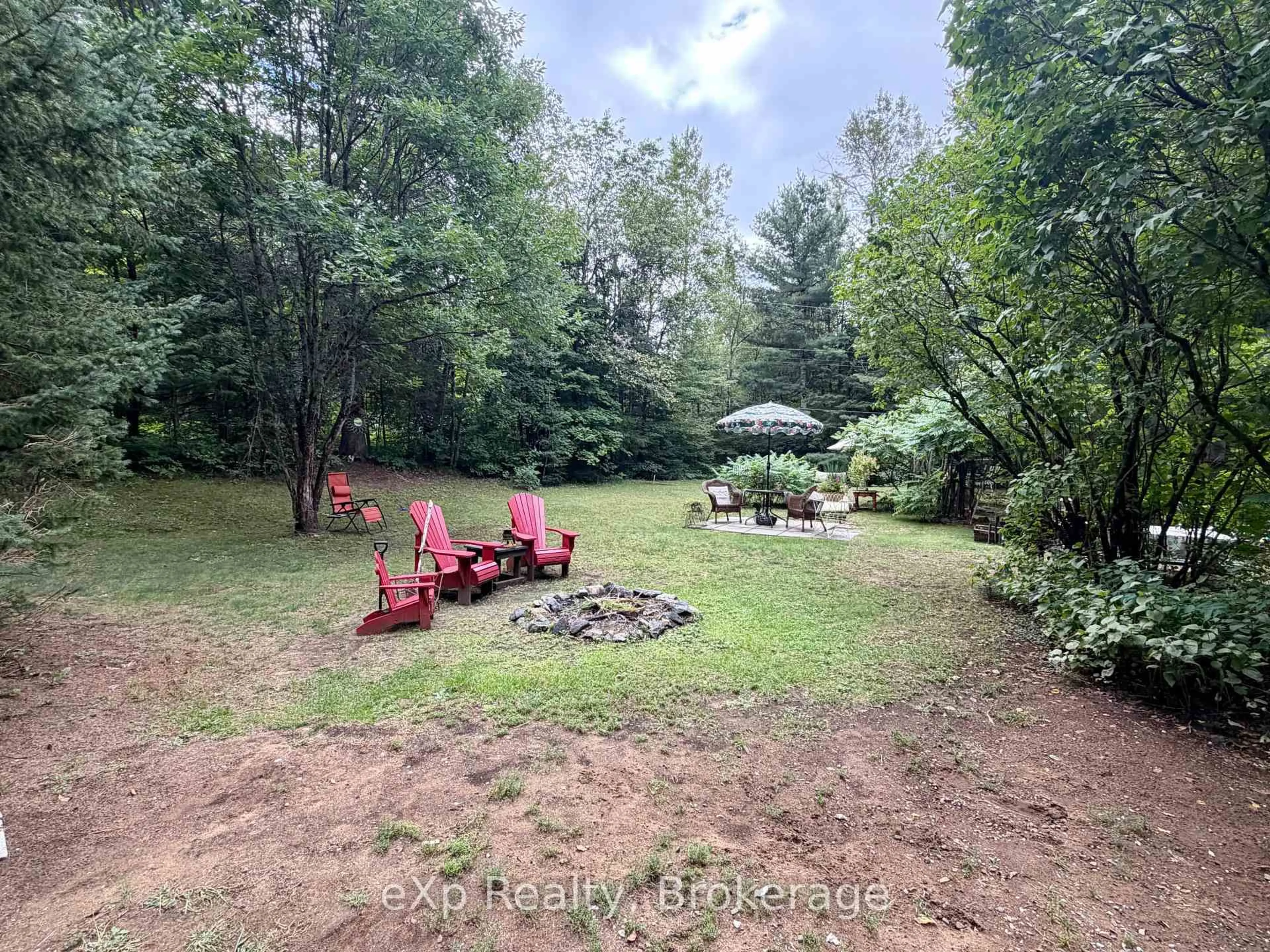 A pic from outside/outdoor area/front of a property/back of a property/a pic from drone, forest/trees view for 1116 Springdale Park Rd, Bracebridge Ontario P1L 1W9