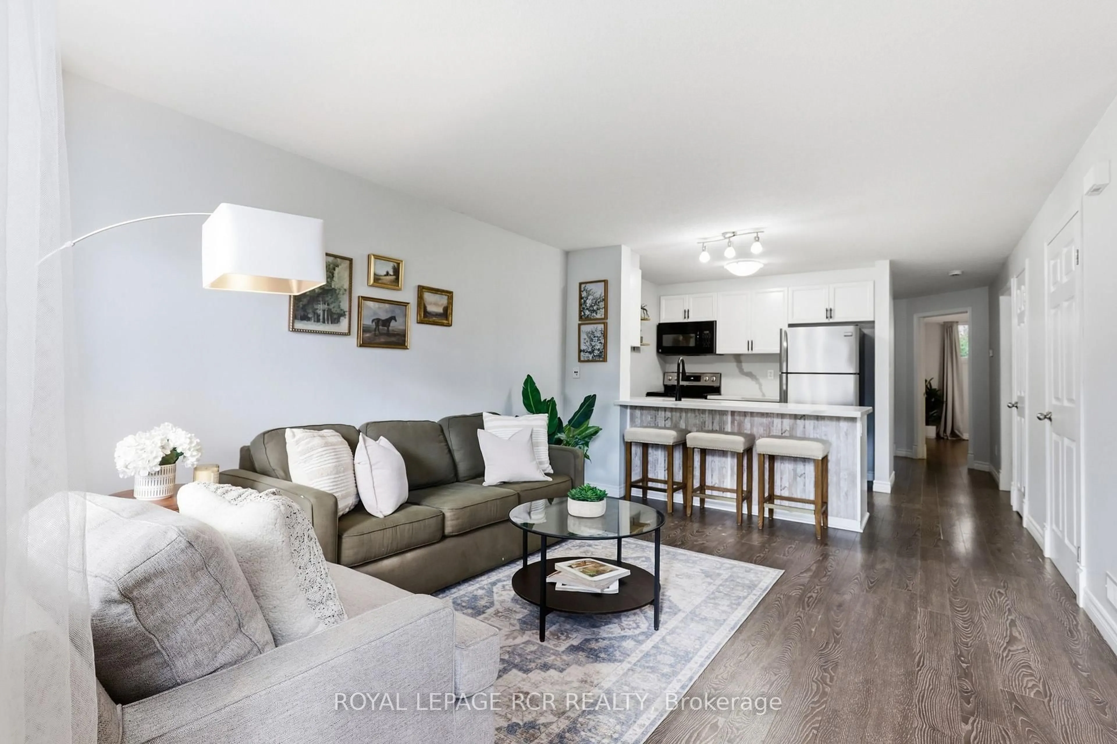 Living room with furniture, wood/laminate floor for 35 MOUNTFORD Dr #25, Guelph Ontario N1E 0G6
