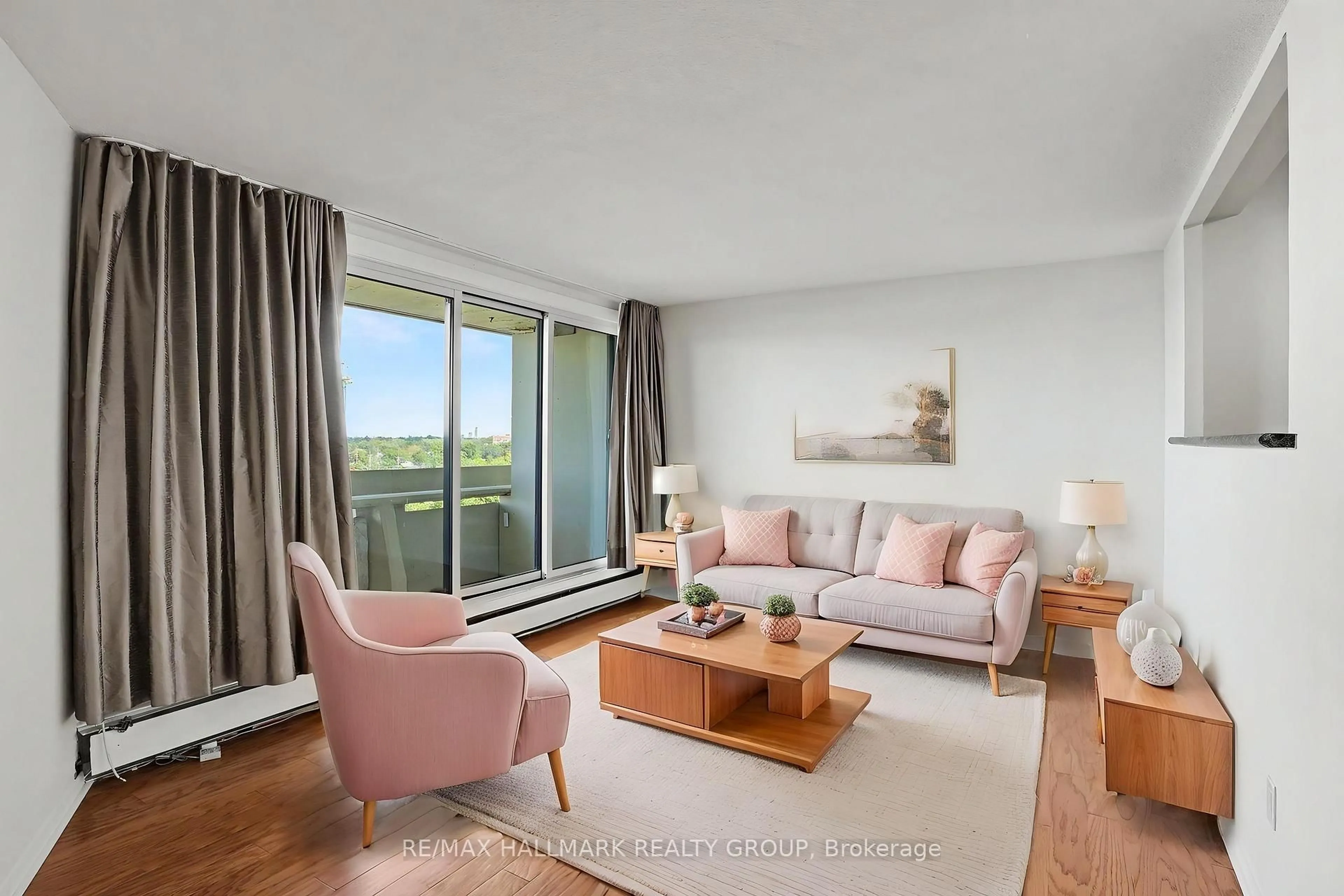 Living room with furniture, wood/laminate floor for 1171 Ambleside Dr #1112, Ottawa Ontario K2B 8E1