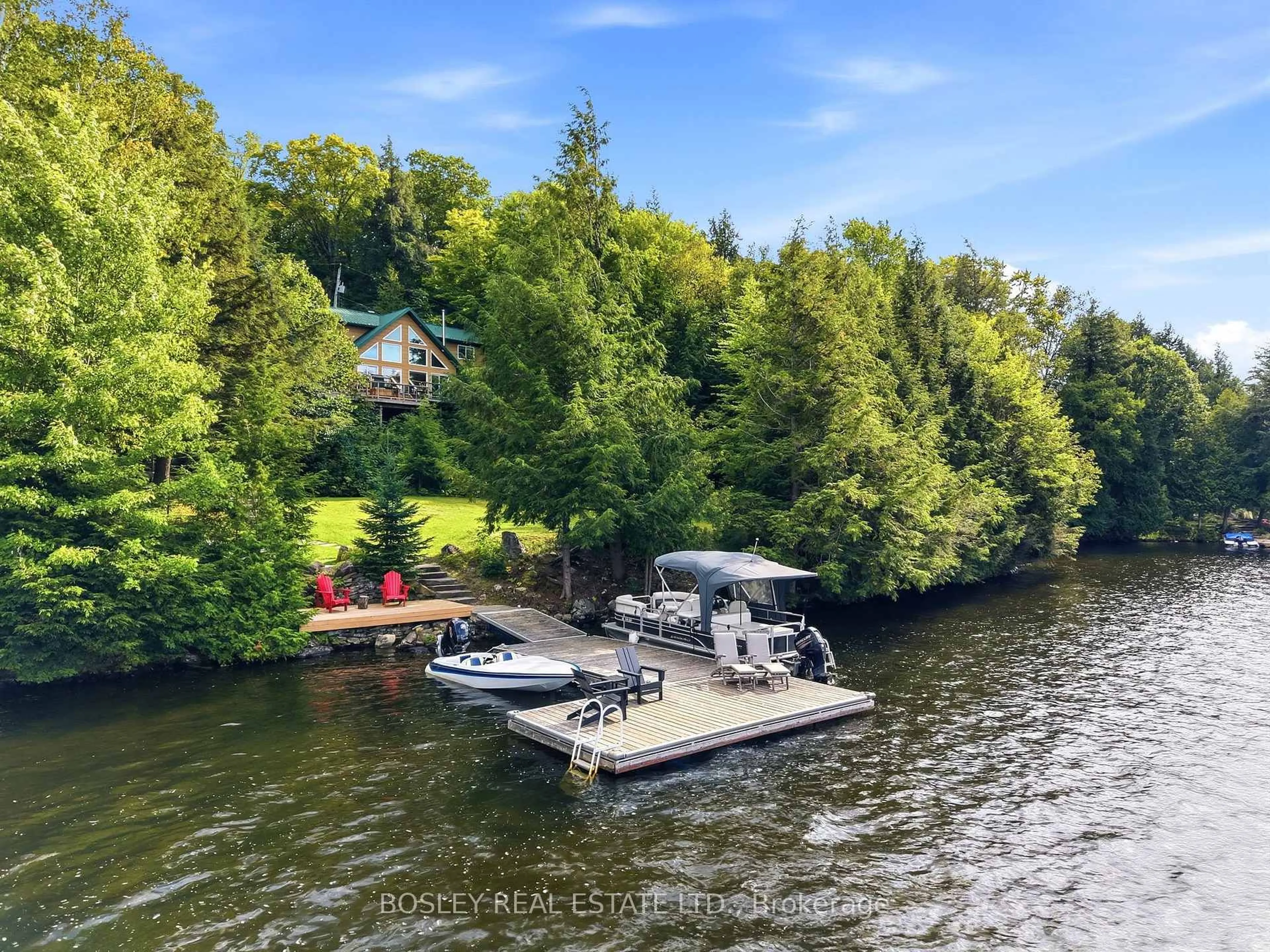 A pic from outside/outdoor area/front of a property/back of a property/a pic from drone, water/lake/river/ocean view for 1143 Rignalls Rd, Bracebridge Ontario P1L 1X1