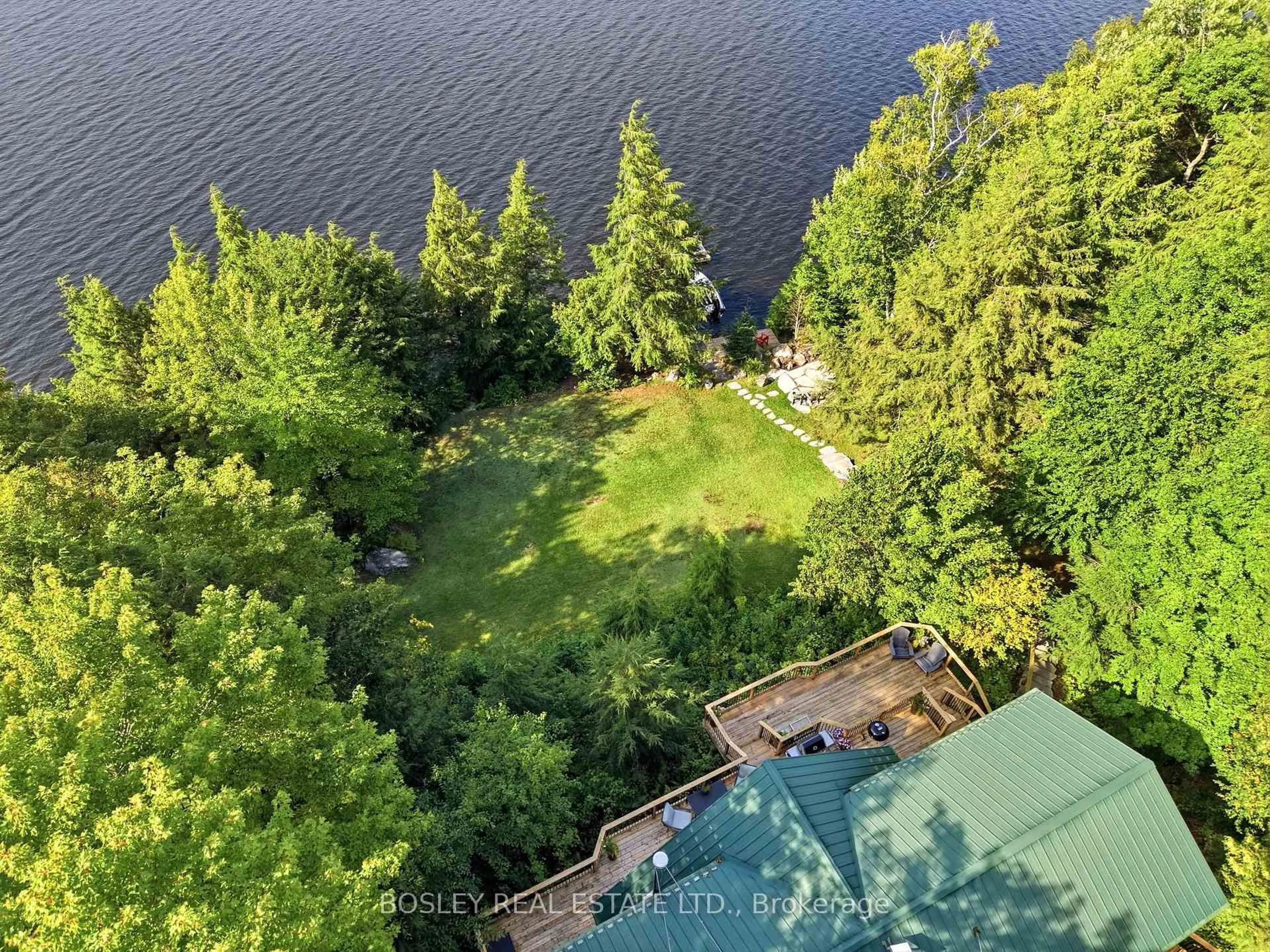A pic from outside/outdoor area/front of a property/back of a property/a pic from drone, water/lake/river/ocean view for 1143 Rignalls Rd, Bracebridge Ontario P1L 1X1