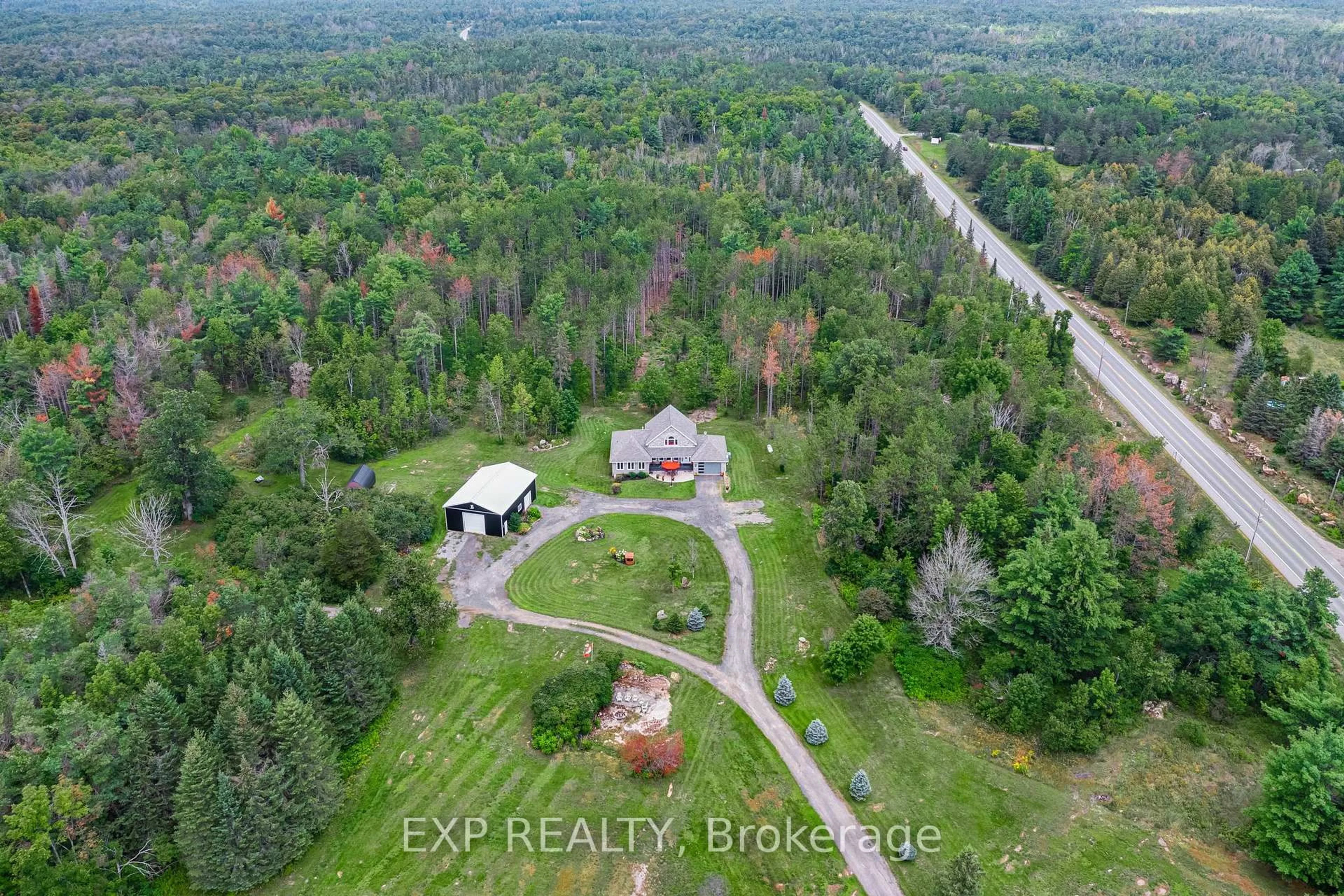 A pic from outside/outdoor area/front of a property/back of a property/a pic from drone, forest/trees view for 6608 Highway 28, North Kawartha Ontario K0L 1A0