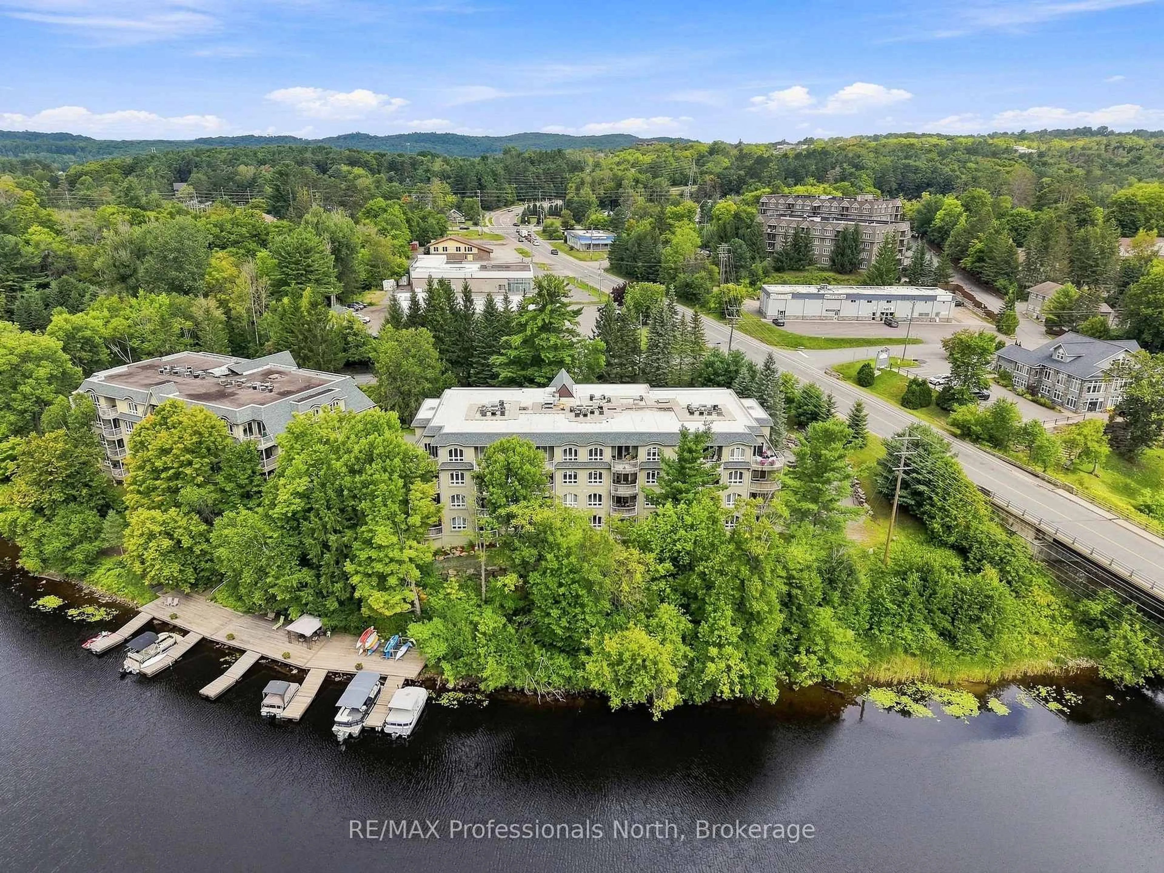 A pic from outside/outdoor area/front of a property/back of a property/a pic from drone, water/lake/river/ocean view for 31 Dairy Lane #306, Huntsville Ontario P1H 2L7