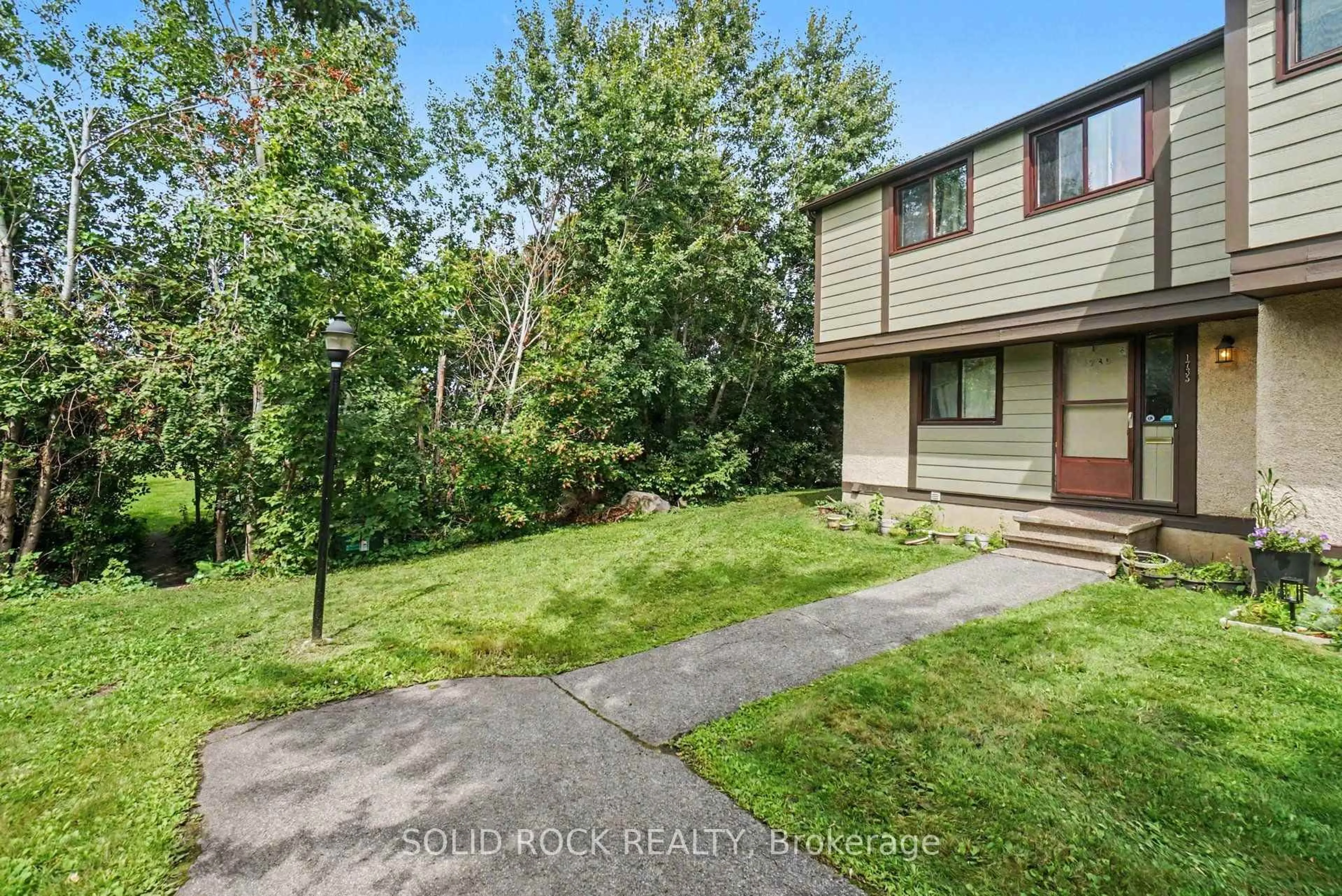 A pic from outside/outdoor area/front of a property/back of a property/a pic from drone, street for 1735 Meadowbrook Rd #71, Ottawa Ontario K1B 4W6