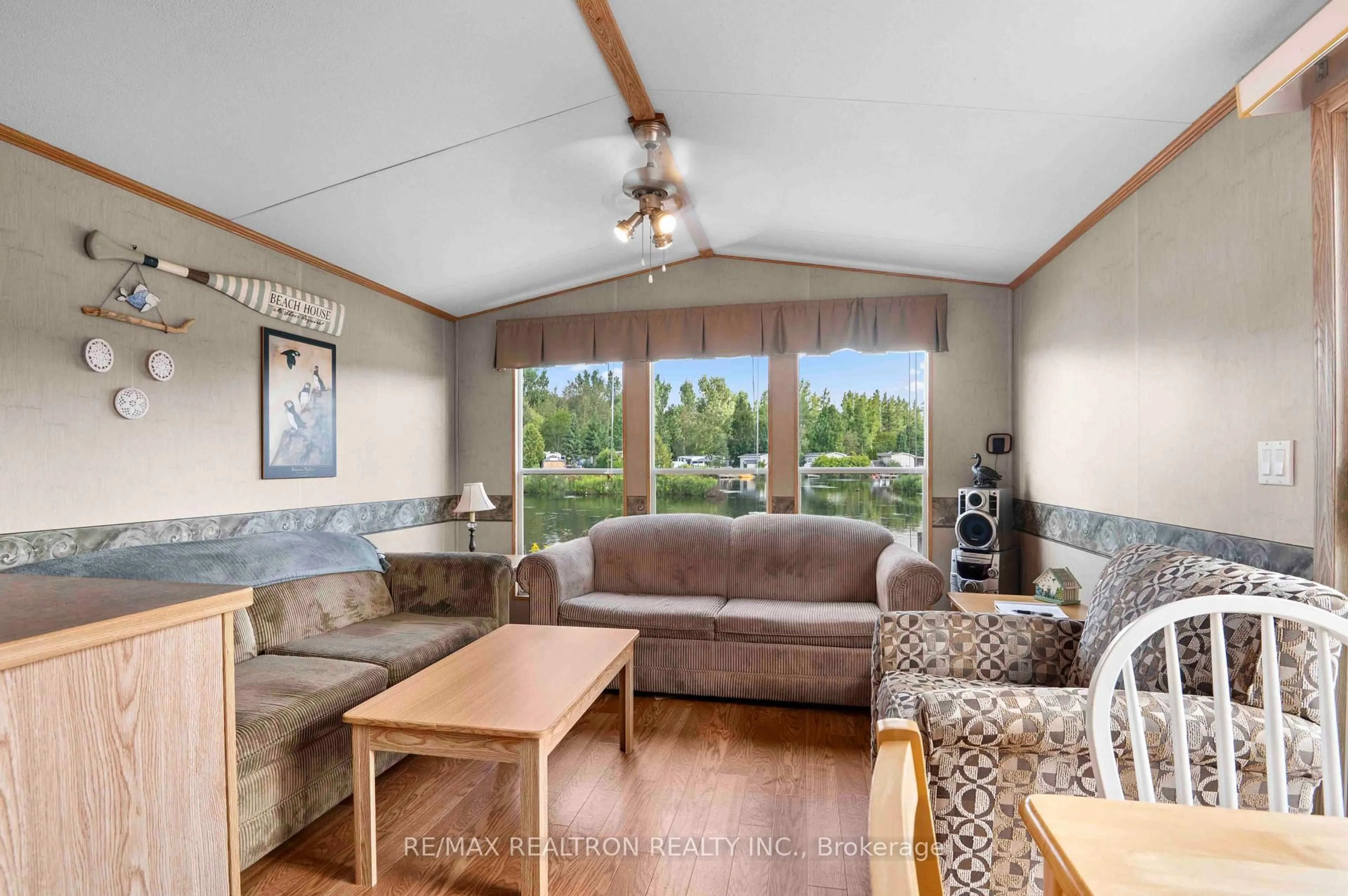 Living room with furniture, wood/laminate floor for 7489 SIDEROAD 5 #T102, Wellington North Ontario N0G 2L0