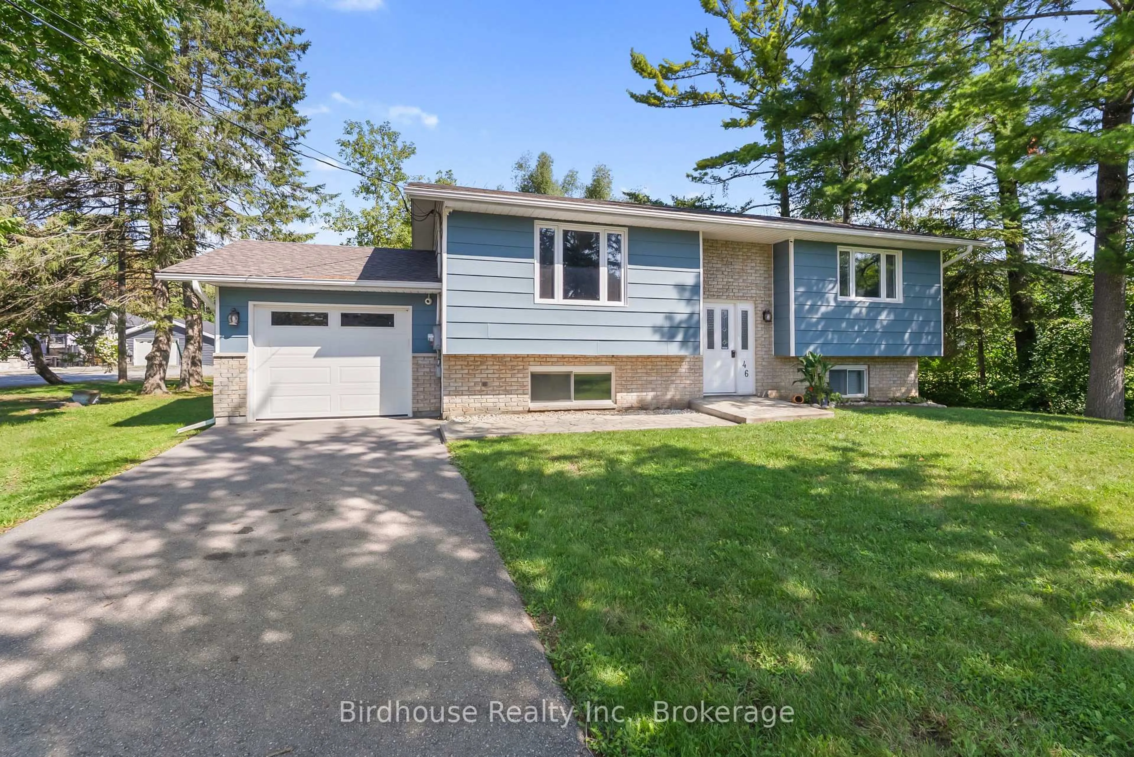 Home with vinyl exterior material, street for 46 Riverside Dr, Kawartha Lakes Ontario K0M 1A0