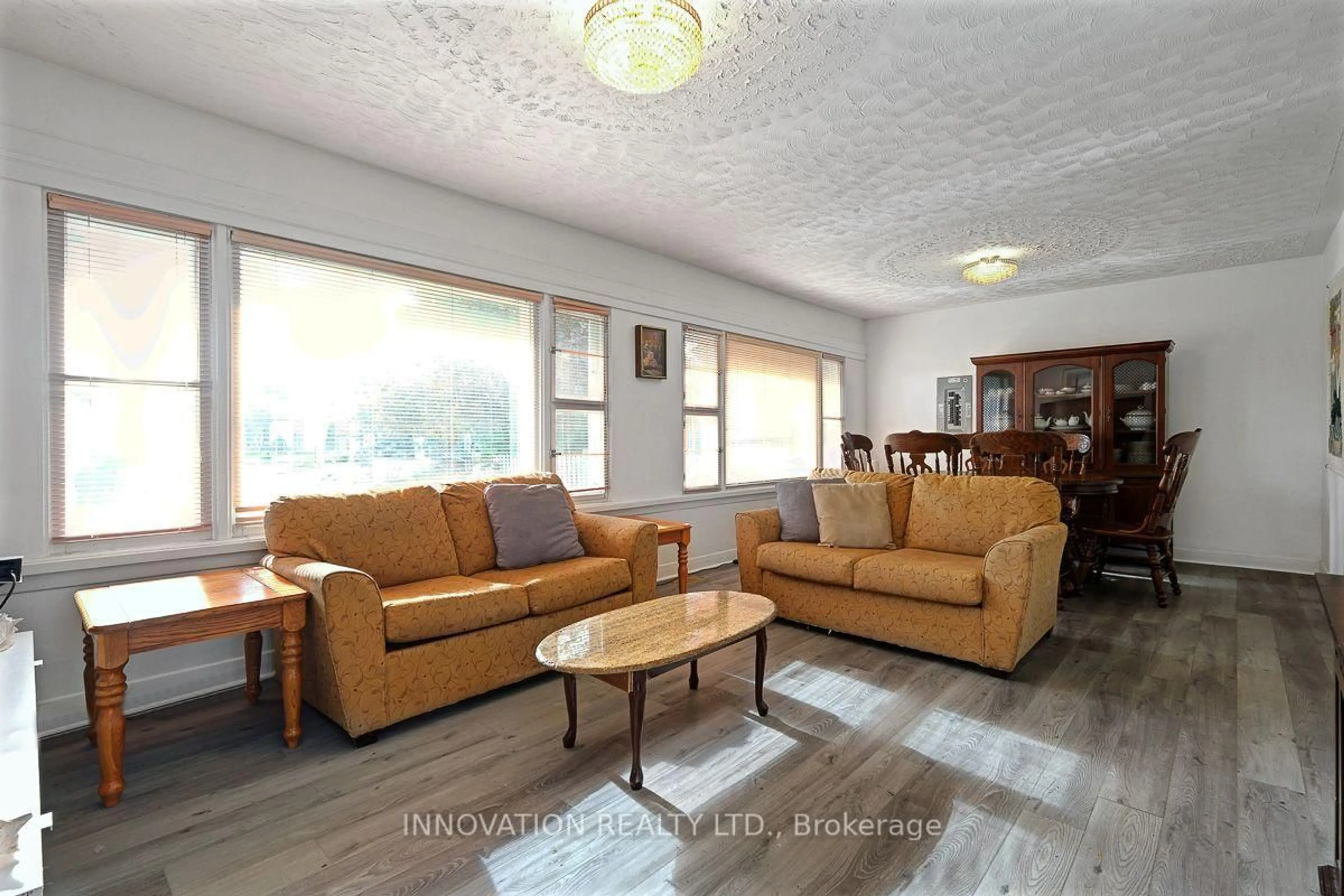 Living room with furniture, wood/laminate floor for 3653 Albion Rd, Ottawa Ontario K1T 1A4