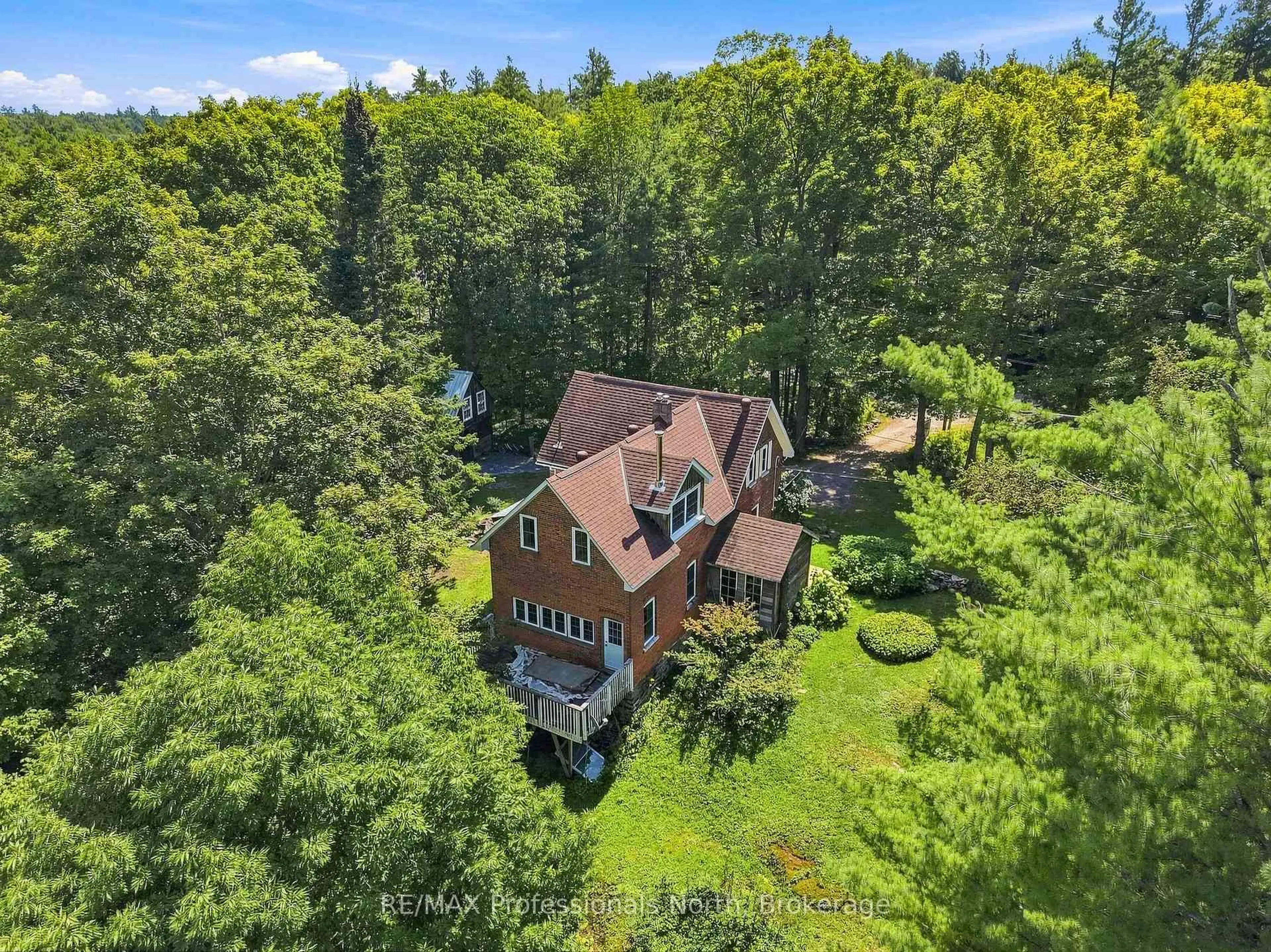 A pic from outside/outdoor area/front of a property/back of a property/a pic from drone, forest/trees view for 1110 Golden Beach Rd, Bracebridge Ontario P1L 1W8