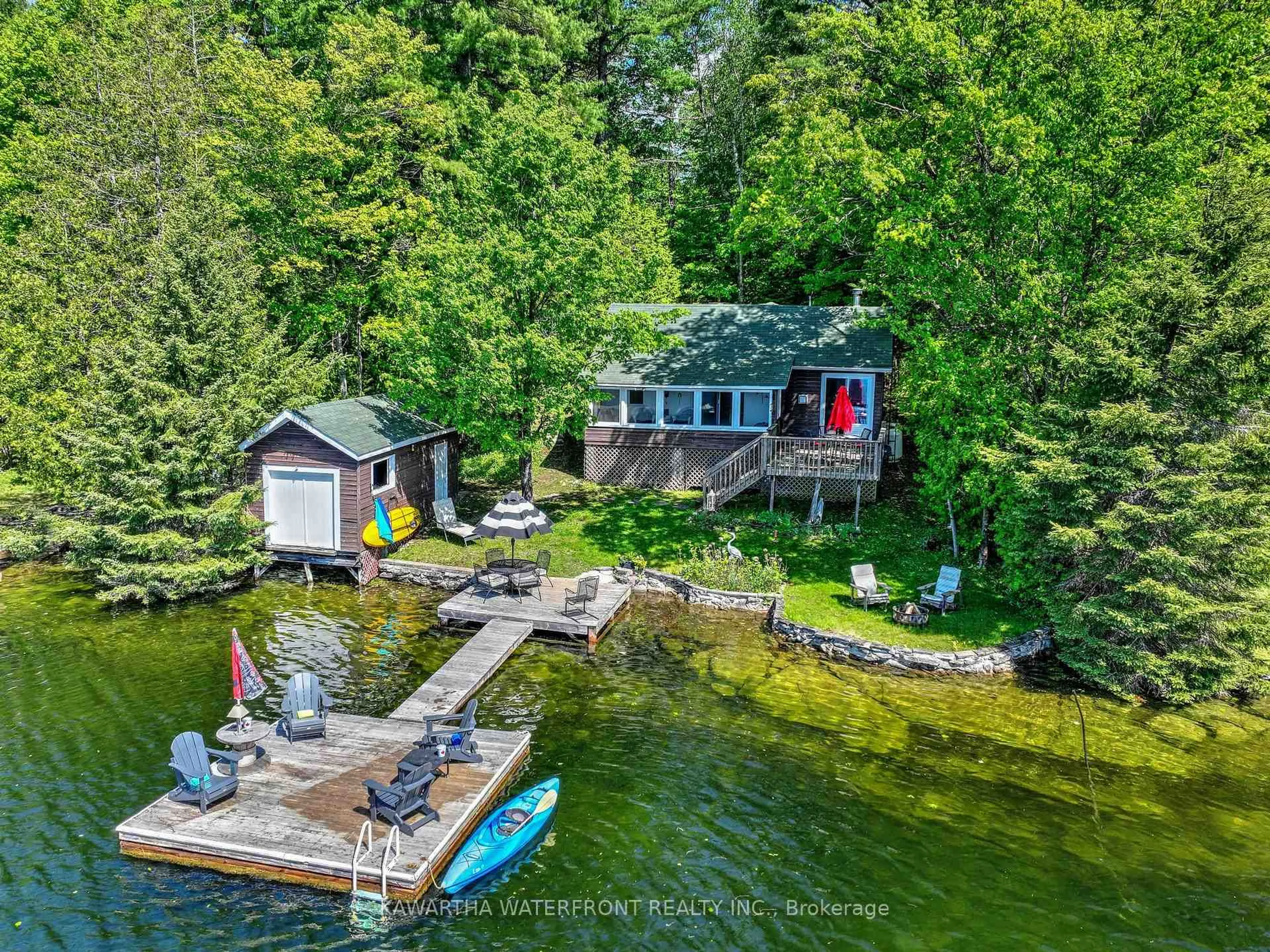 A pic from outside/outdoor area/front of a property/back of a property/a pic from drone, water/lake/river/ocean view for 93 West Clear Bay Rd, Trent Lakes Ontario K0M 2A0