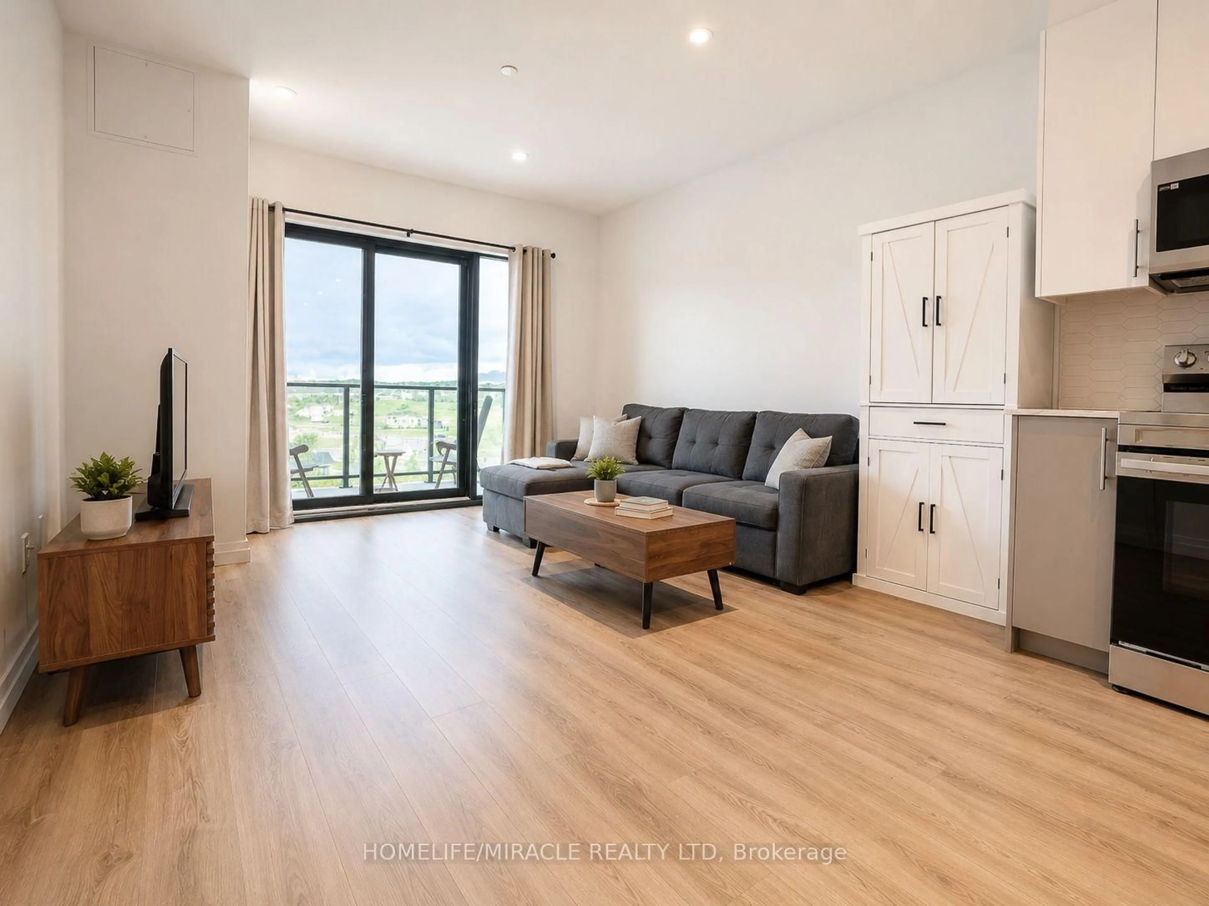 Living room with furniture, wood/laminate floor for 525 New Dundee Rd #516, Kitchener Ontario N2P 0K8