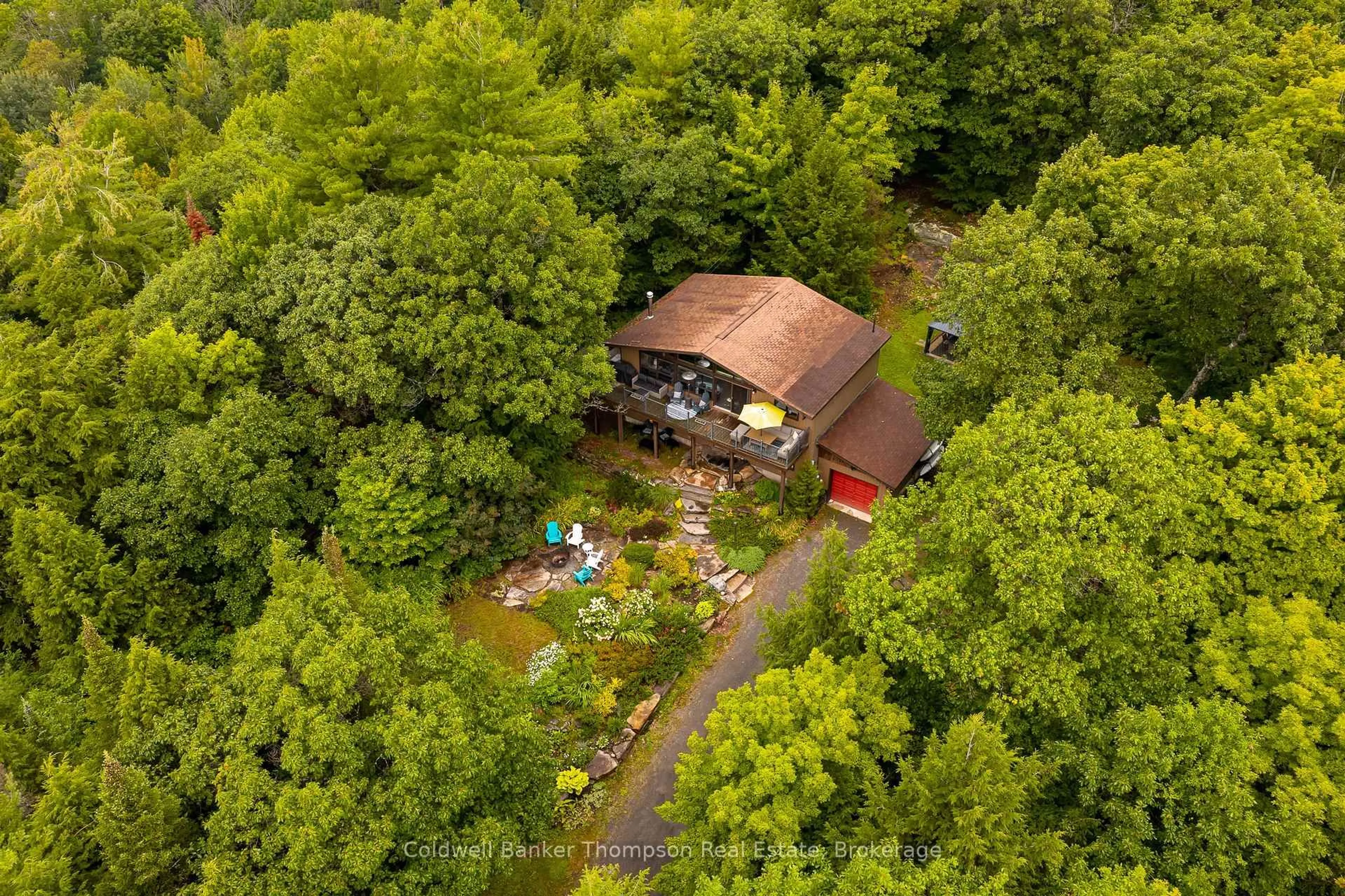 A pic from outside/outdoor area/front of a property/back of a property/a pic from drone, forest/trees view for 165 Golden Pheasant Dr, Huntsville Ontario P1H 1B3