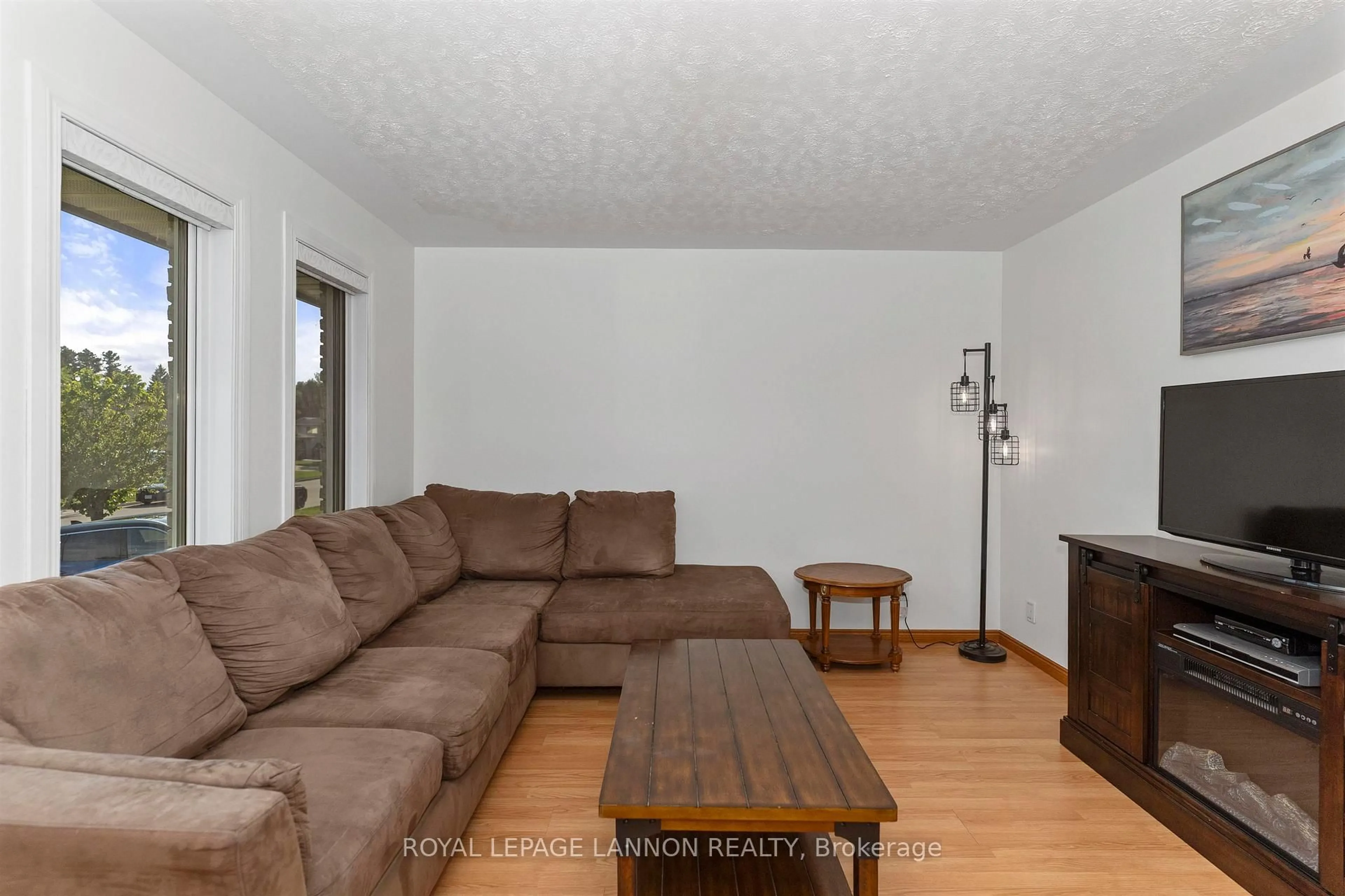 Living room with furniture, wood/laminate floor for 49 Wasco Dr, Thunder Bay Ontario P7G 1A2