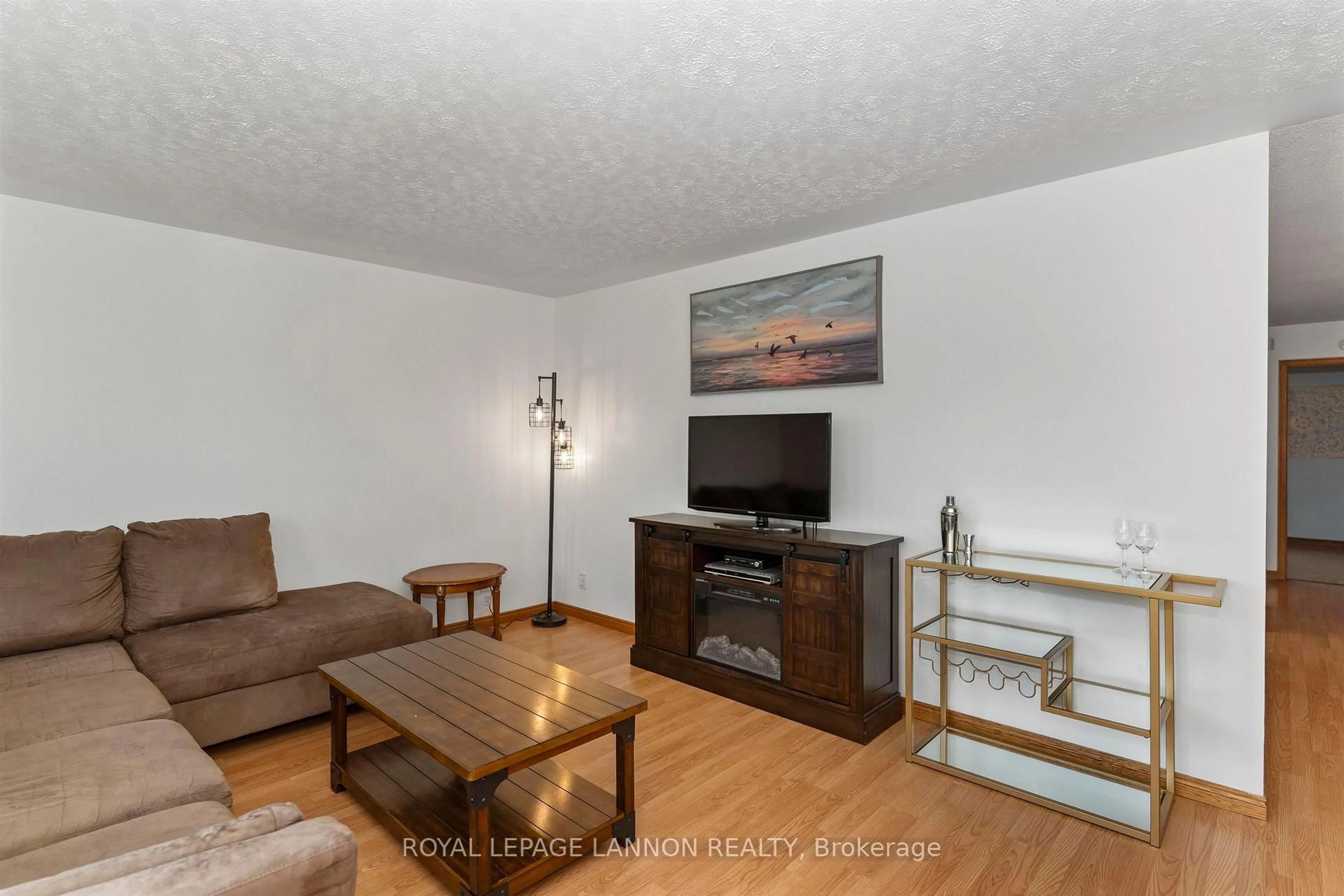 Living room with furniture, wood/laminate floor for 49 Wasco Dr, Thunder Bay Ontario P7G 1A2