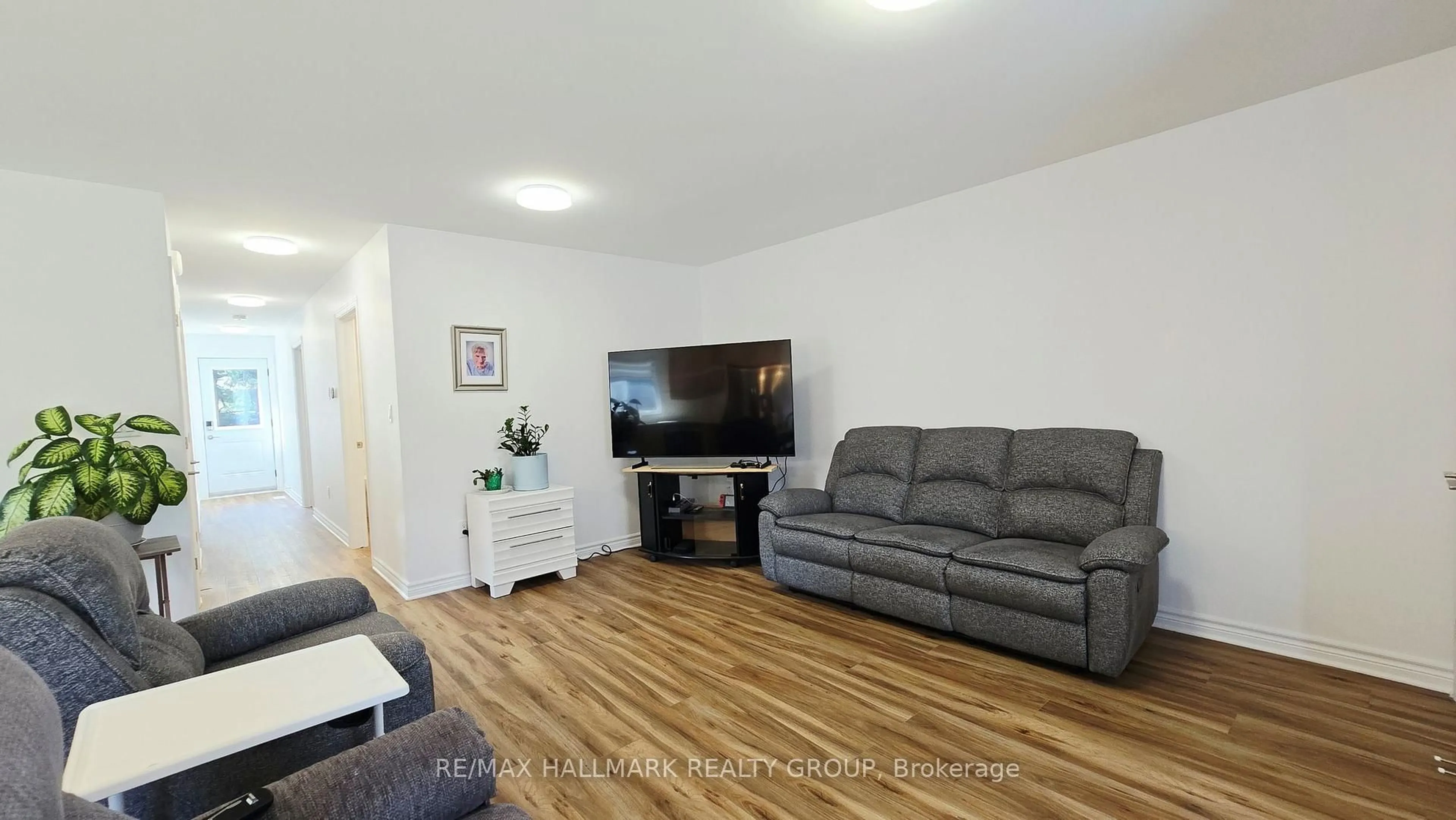 Living room with furniture, wood/laminate floor for 221 Castlefrank Rd, Kanata Ontario K2L 1T4