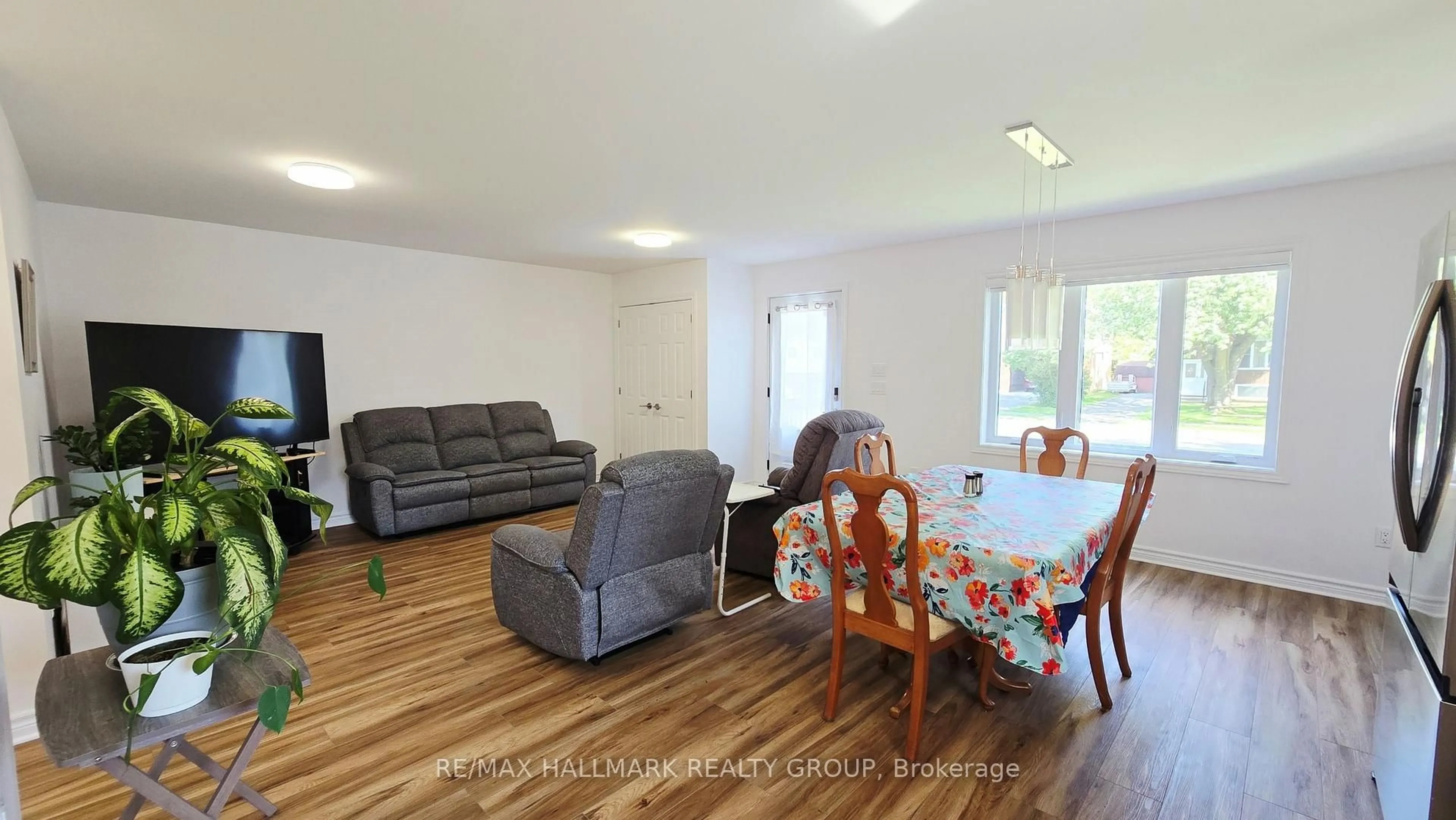 Living room with furniture, wood/laminate floor for 221 Castlefrank Rd, Kanata Ontario K2L 1T4