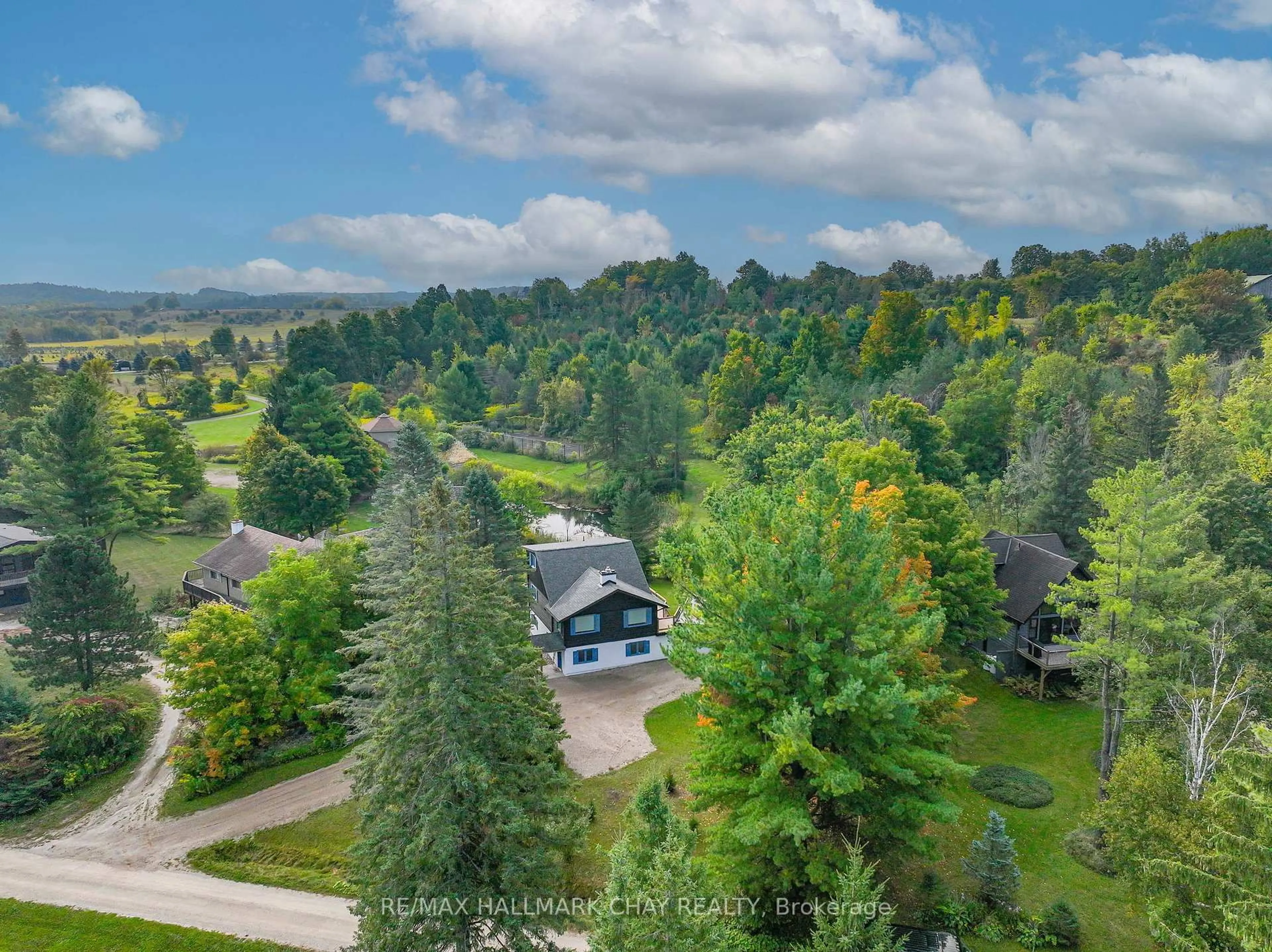 A pic from outside/outdoor area/front of a property/back of a property/a pic from drone, forest/trees view for 61 Pine River Cres, Mulmur Ontario L9V 3H3