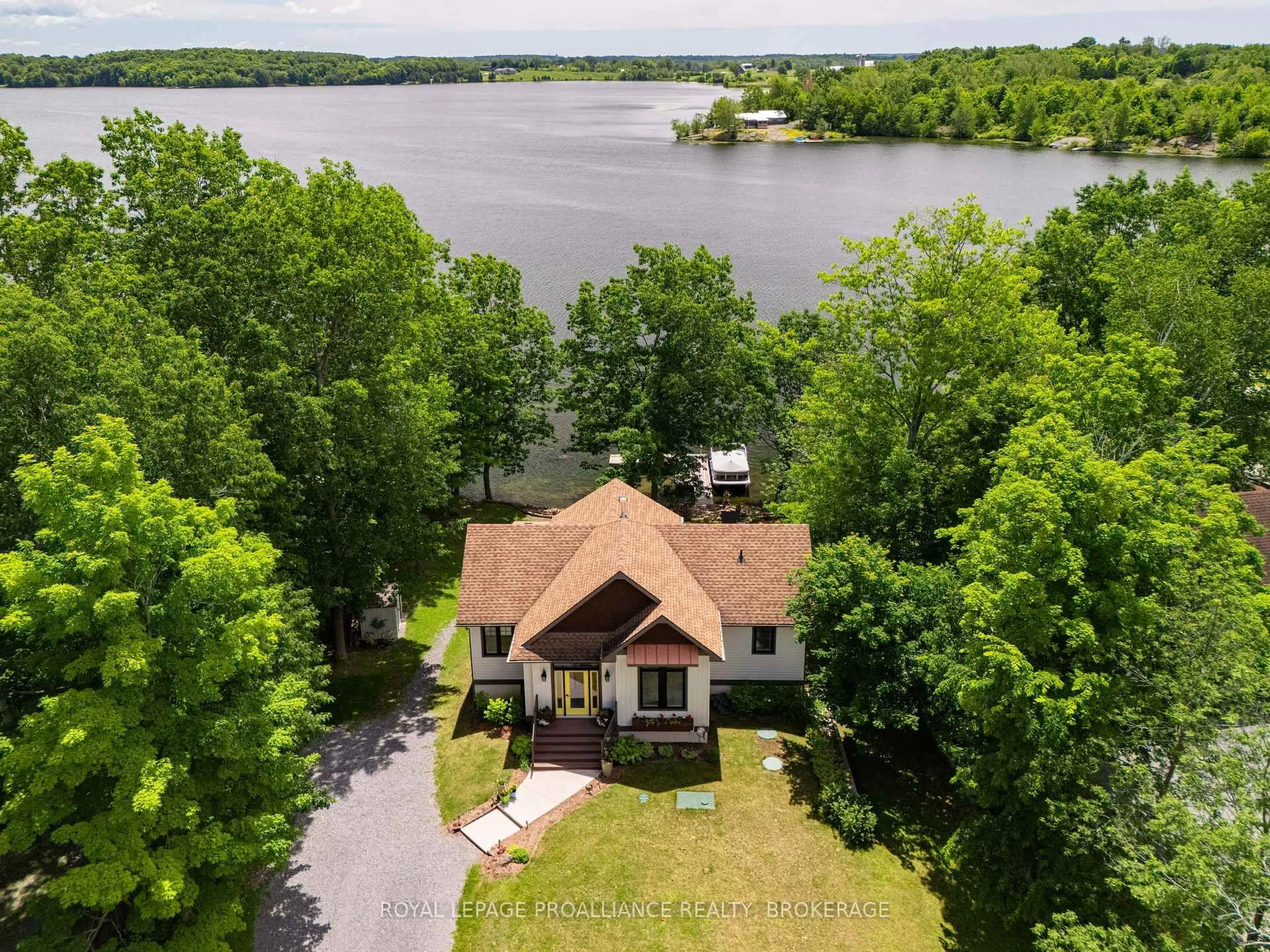 A pic from outside/outdoor area/front of a property/back of a property/a pic from drone, water/lake/river/ocean view for 3842 Hideaway Lane, Battersea Ontario K0H 1H0