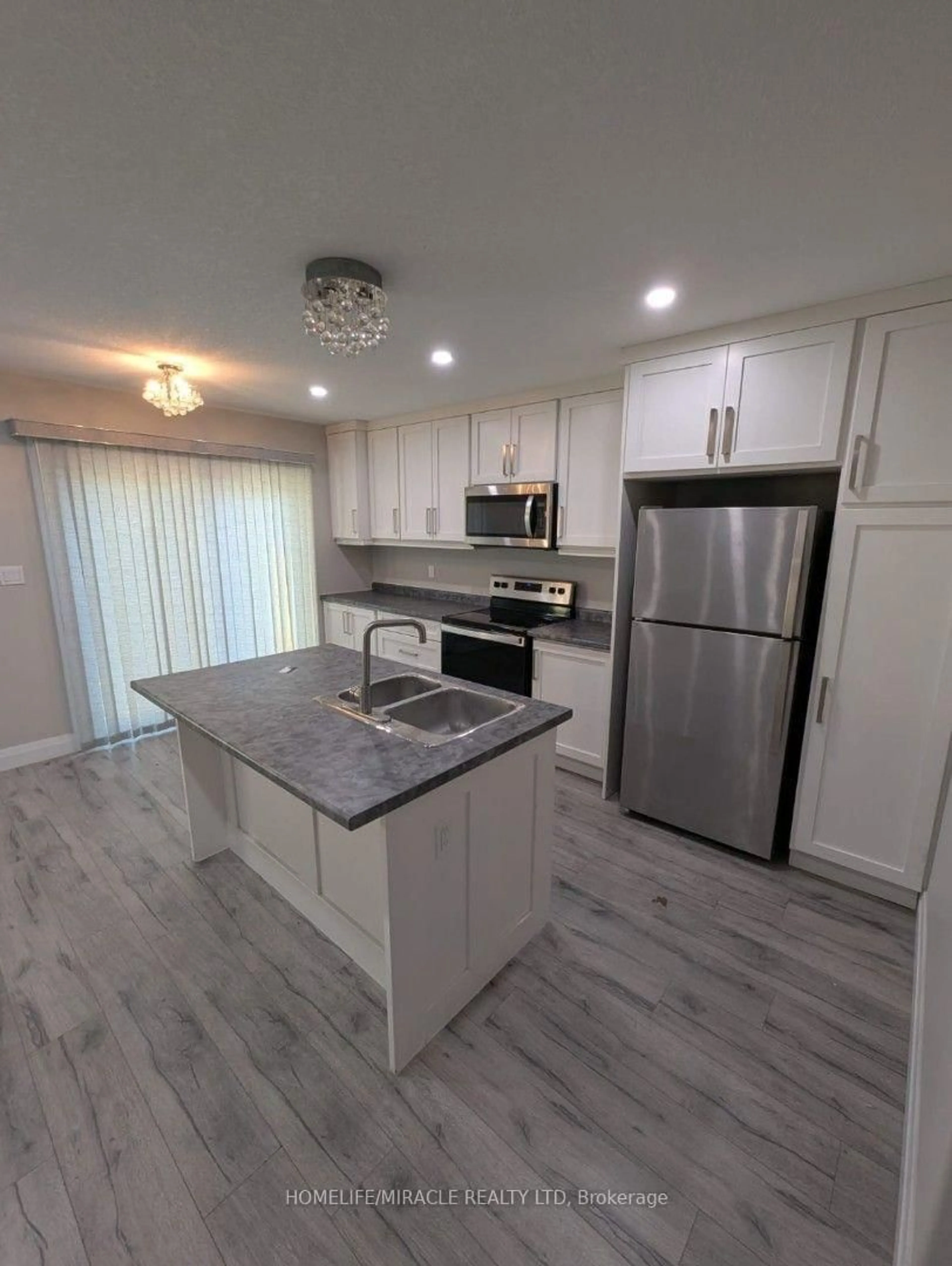 Open concept kitchen, wood/laminate floor for 61 Vienna Rd #1, Tillsonburg Ontario N4G 0J6