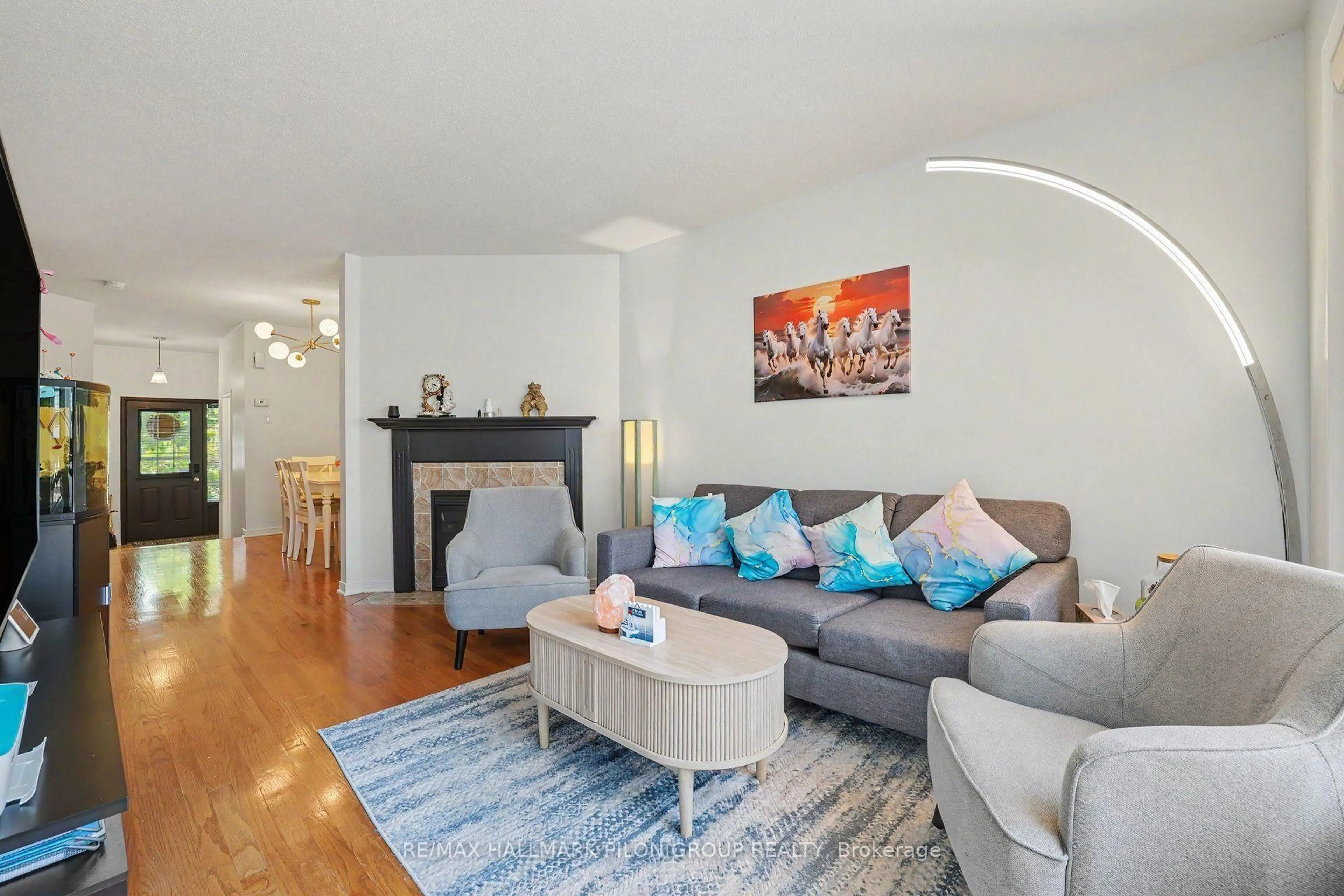 Living room with furniture, wood/laminate floor for 244 Rolling Meadow Cres, Ottawa Ontario K1W 0A8