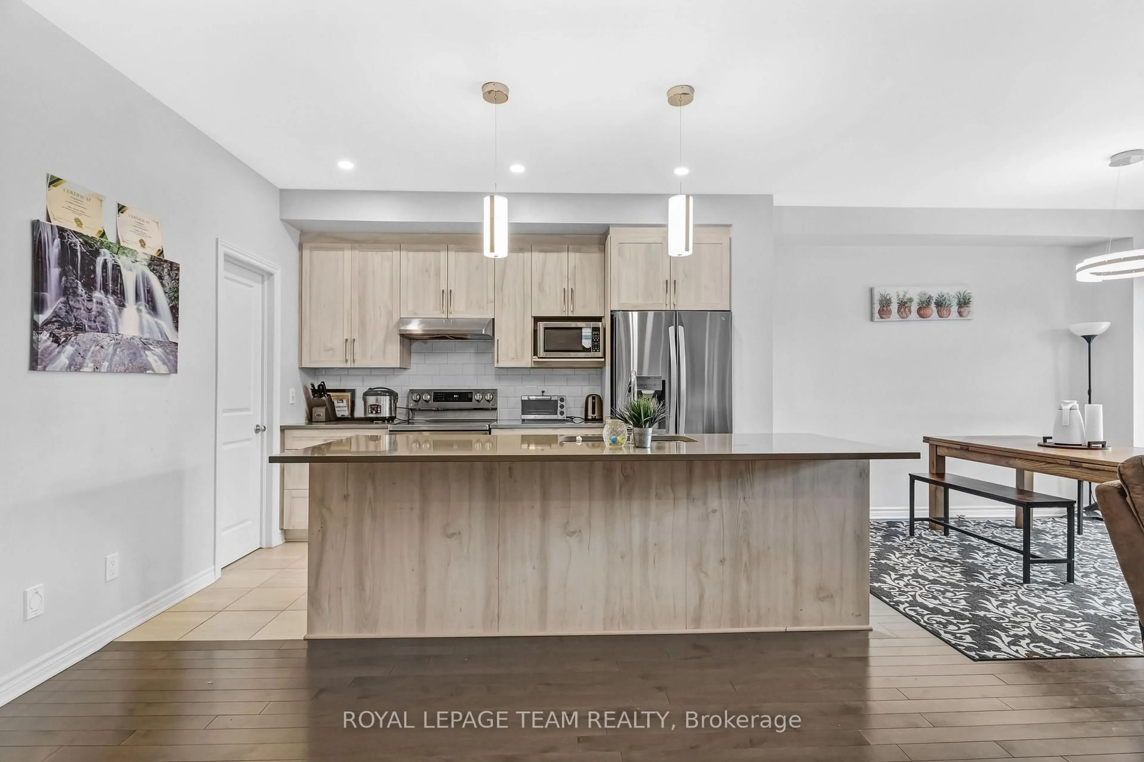 Open concept kitchen, wood/laminate floor for 310 Kanashtage Terr, Ottawa Ontario K4A 5J9