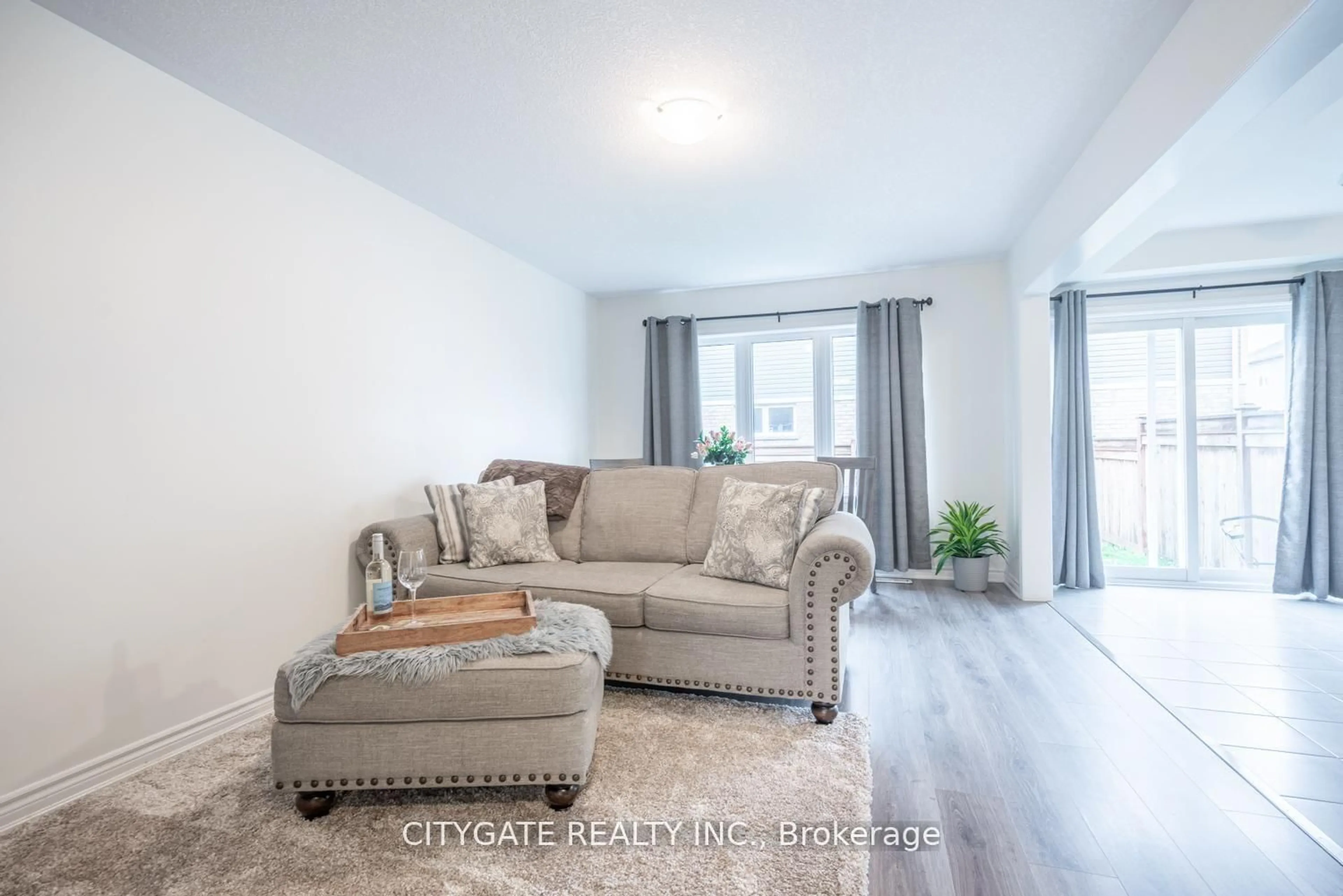 Living room with furniture, wood/laminate floor for 69 Mcmonies Dr, Hamilton Ontario L8B 0A5