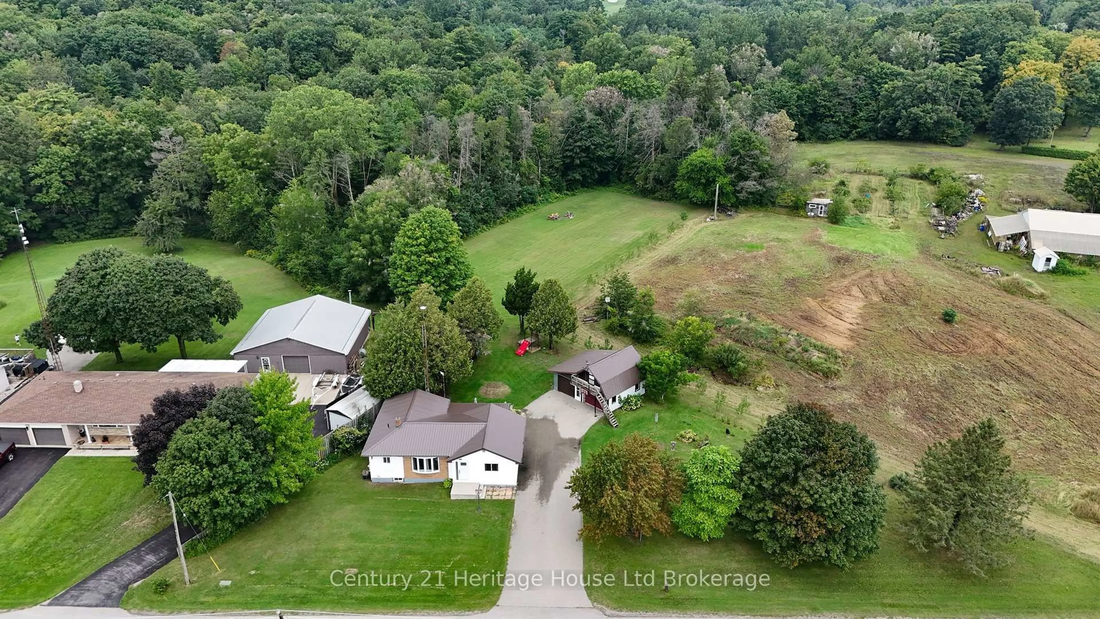 A pic from outside/outdoor area/front of a property/back of a property/a pic from drone, forest/trees view for 185559 Cornell Rd, Norwich Ontario N0J 1R0