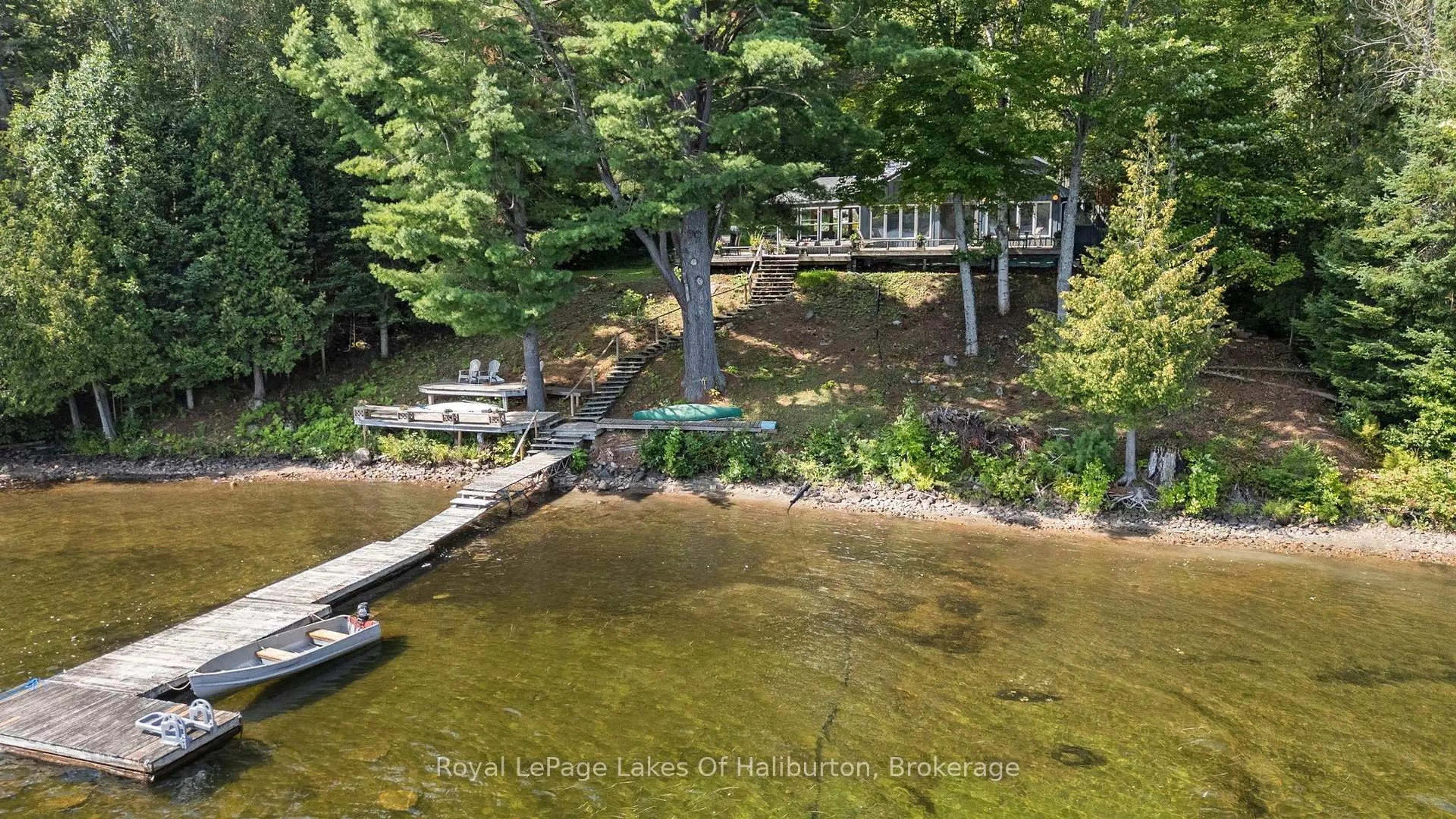 A pic from outside/outdoor area/front of a property/back of a property/a pic from drone, water/lake/river/ocean view for 1035 Triple Creek Lane, Algonquin Highlands Ontario K0M 1S0