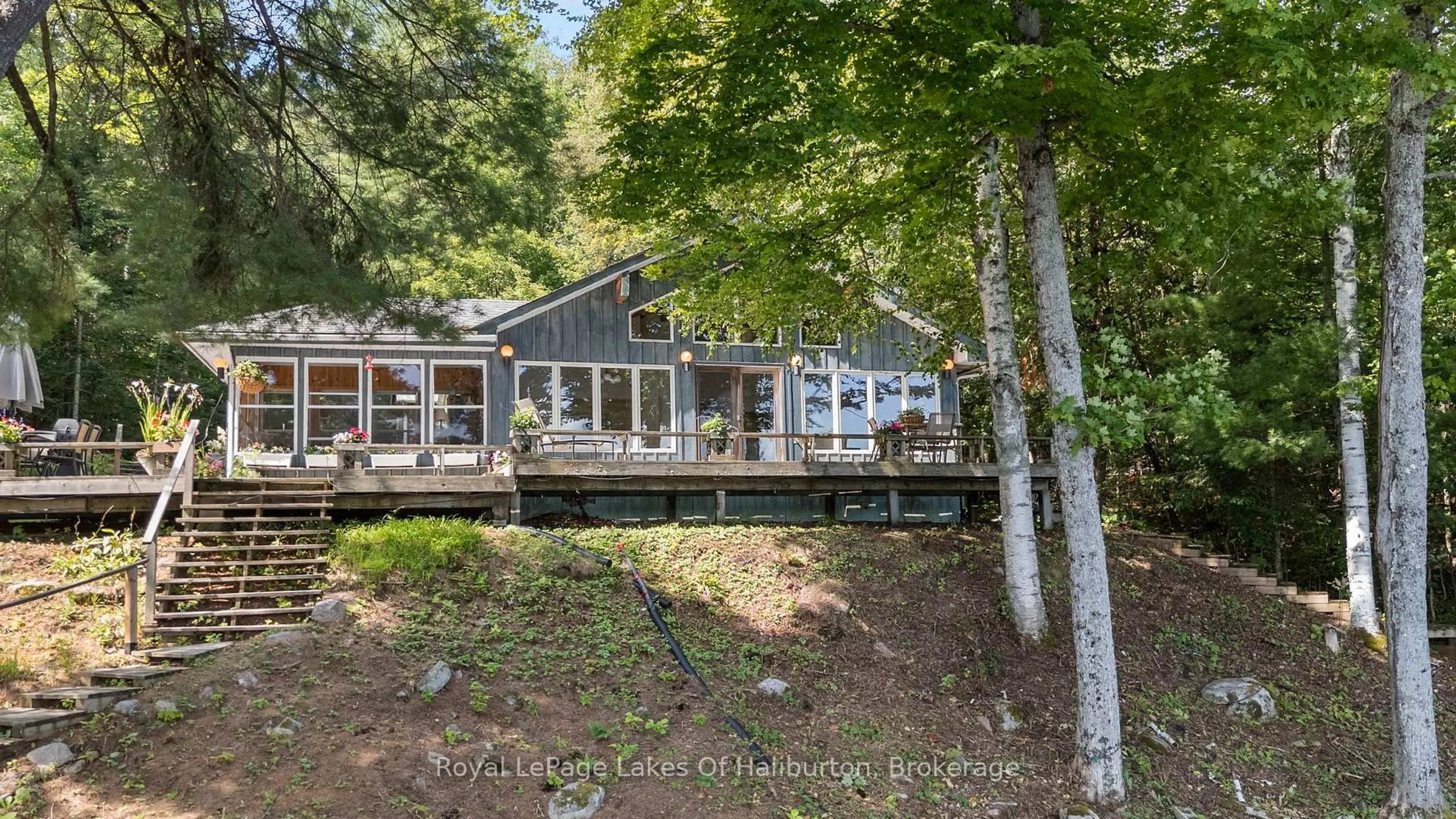 A pic from outside/outdoor area/front of a property/back of a property/a pic from drone, water/lake/river/ocean view for 1035 Triple Creek Lane, Algonquin Highlands Ontario K0M 1S0