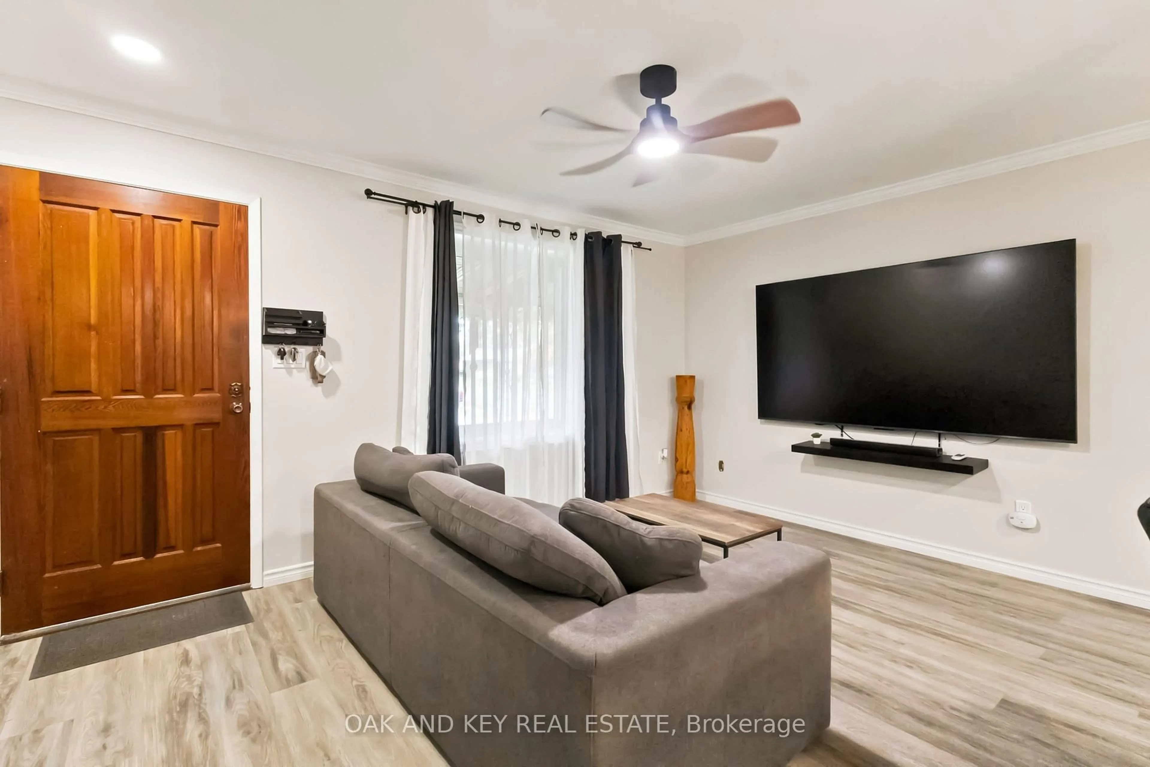 Living room with furniture, wood/laminate floor for 1 Vanier Pl, St. Thomas Ontario N5R 5L2