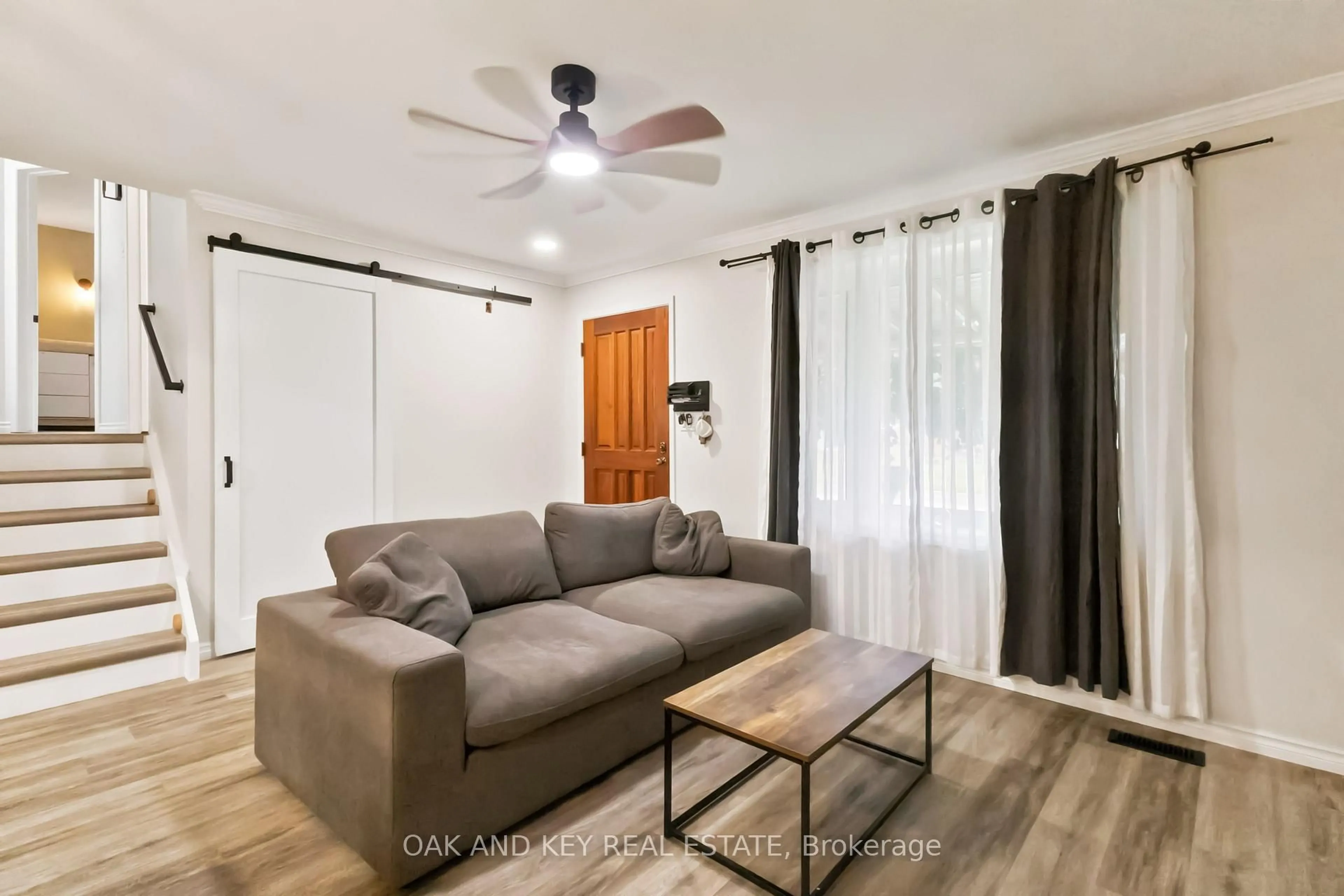 Living room with furniture, wood/laminate floor for 1 Vanier Pl, St. Thomas Ontario N5R 5L2