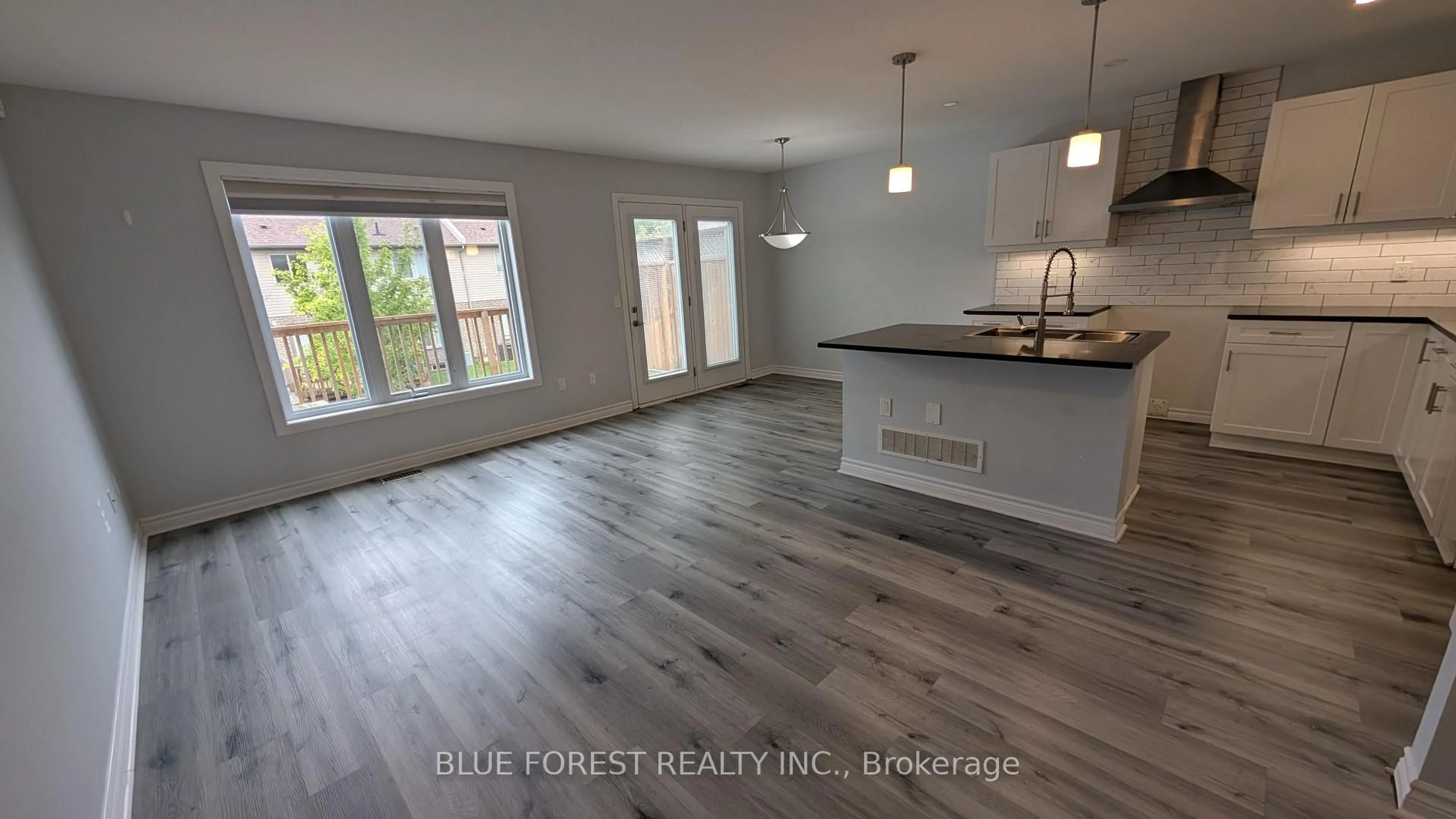 Open concept kitchen, wood/laminate floor for 3400 Castle Rock Pl #104, London South Ontario N6L 0E4