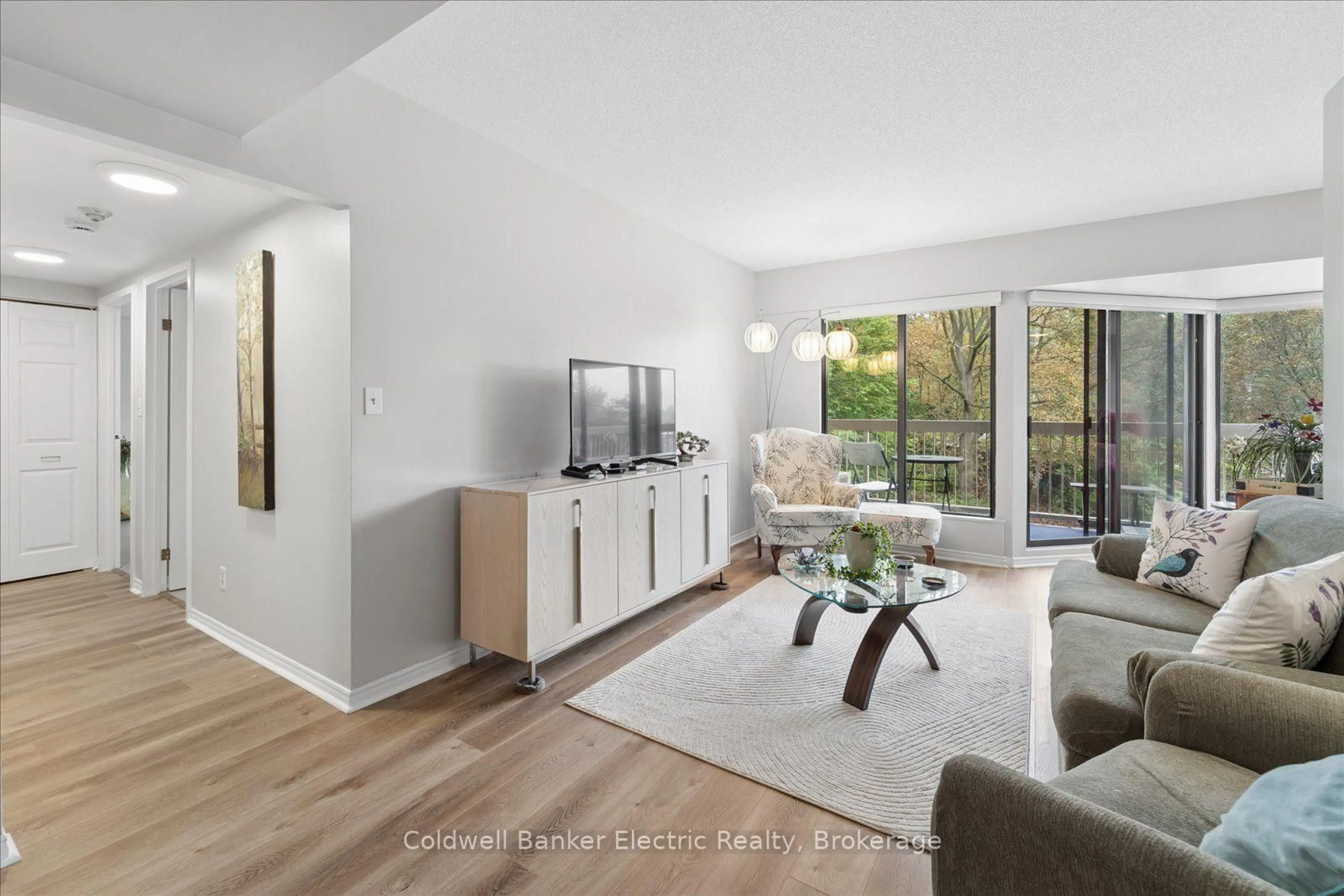 Living room with furniture, wood/laminate floor for 40 Auburn St #206, Peterborough Ontario K9H 2G2