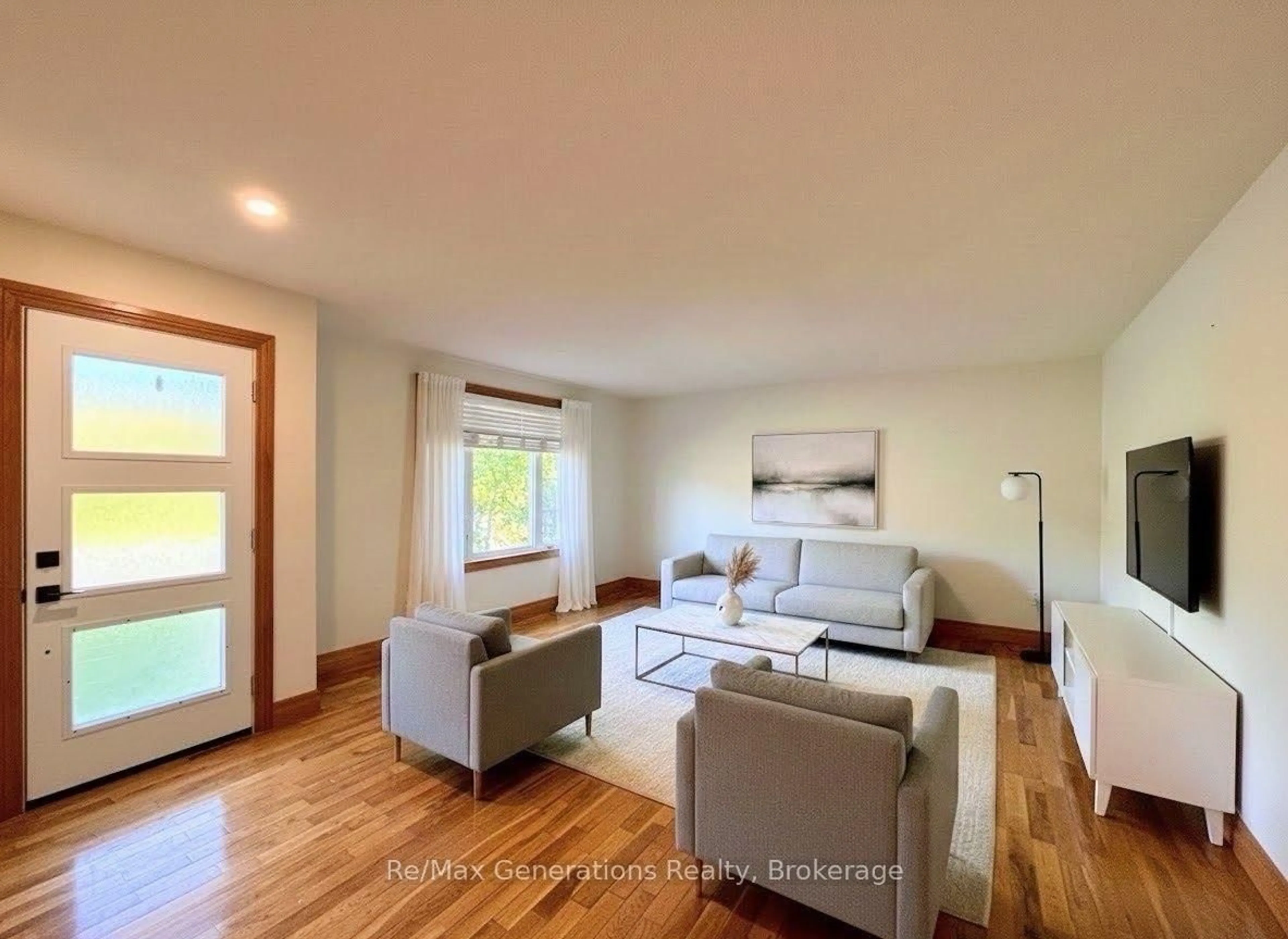 Living room with furniture, wood/laminate floor for 34 Redwing Ave, Manitouwadge Ontario P0T 2C0