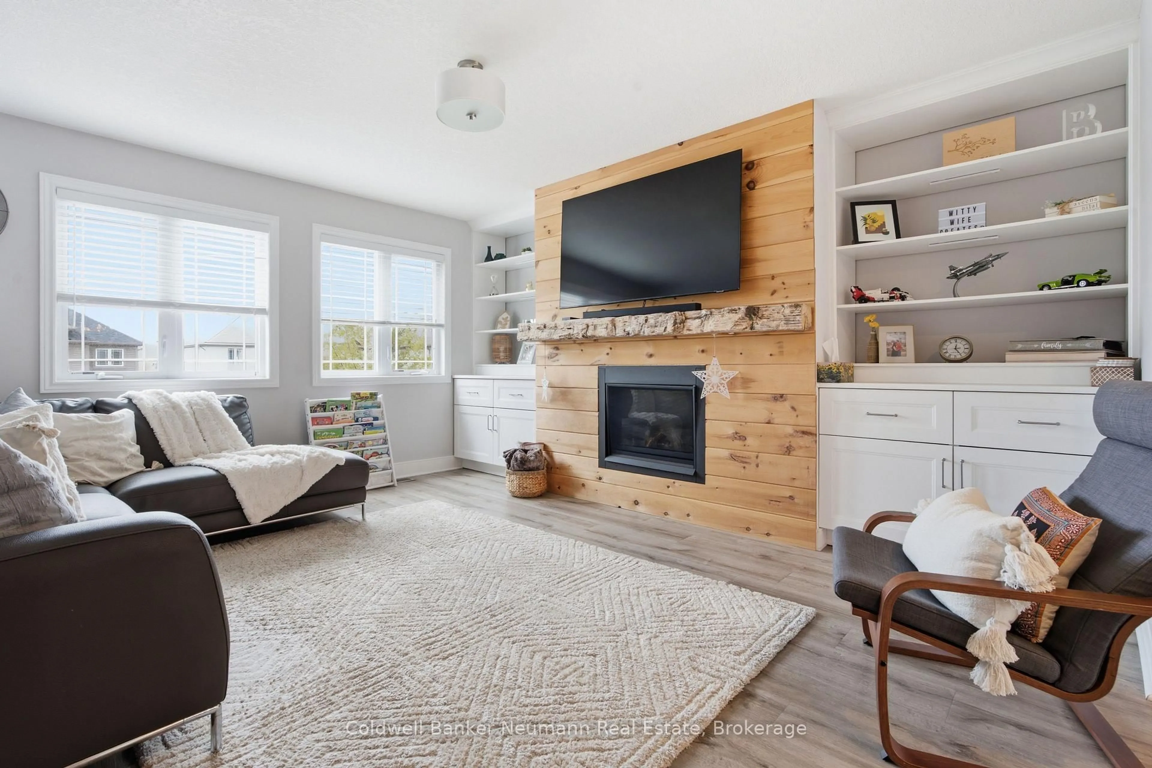 Living room with furniture, wood/laminate floor for 110 Oakes Cres, Guelph Ontario N1E 0J5