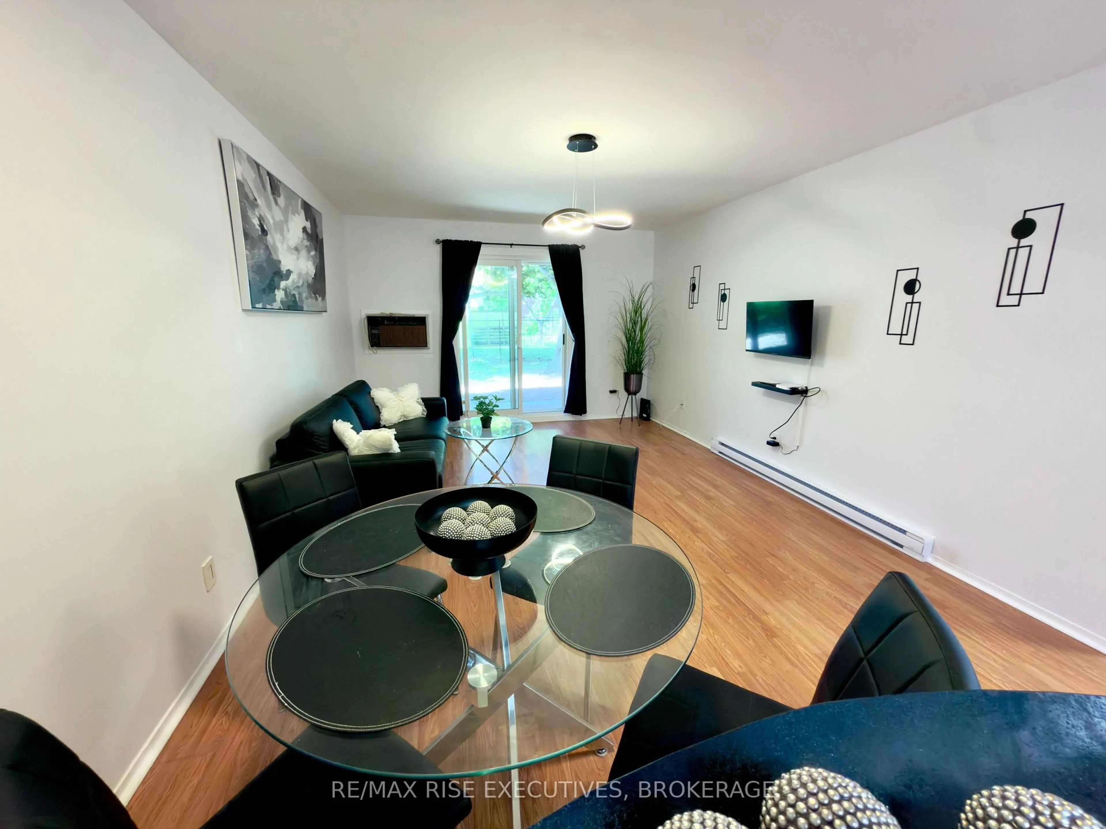 Living room with furniture, wood/laminate floor for 573 Armstrong Rd #101, Kingston Ontario K7M 8J8