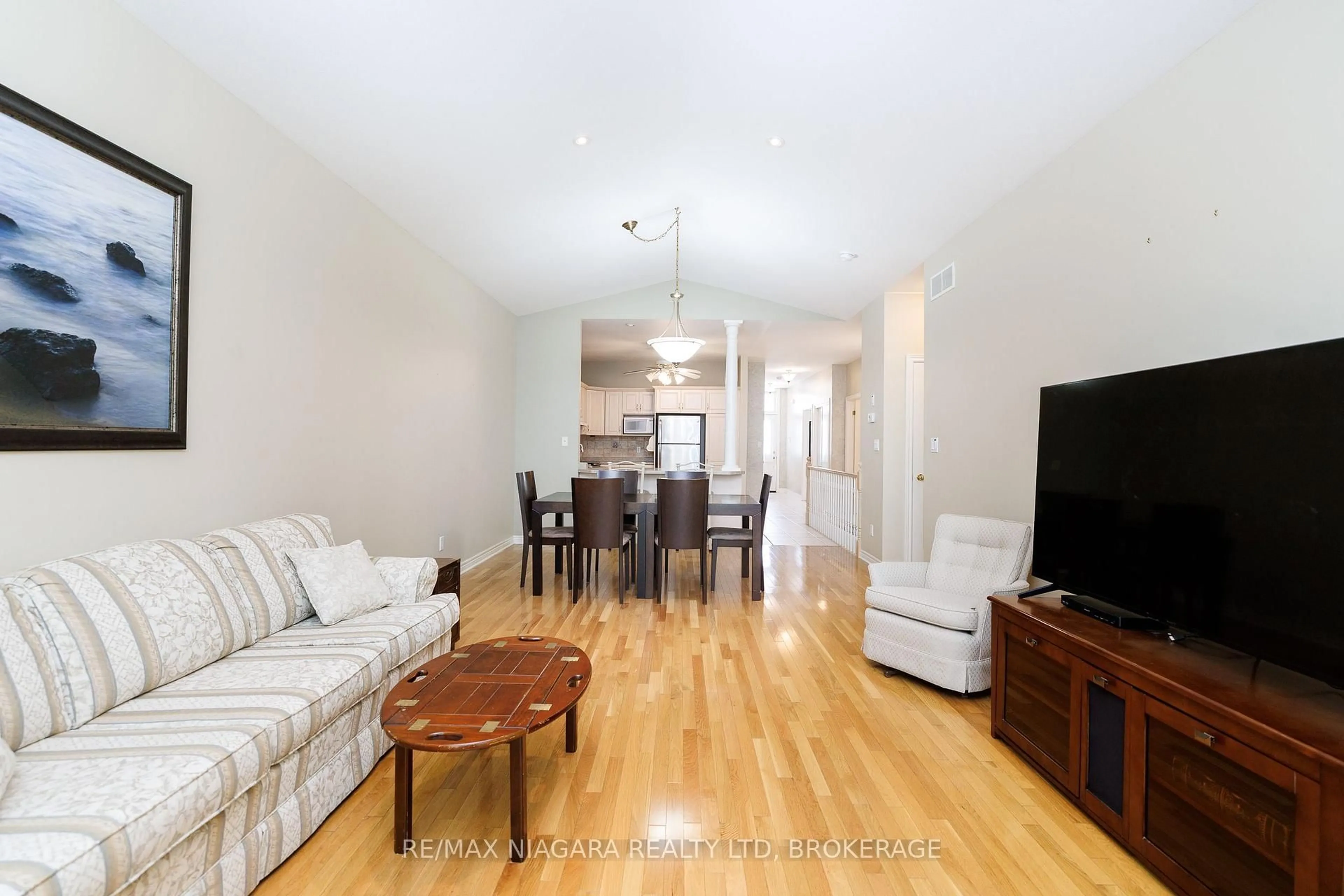 Living room with furniture, wood/laminate floor for 3300 Montrose Rd #8, Niagara Falls Ontario L2H 3L9